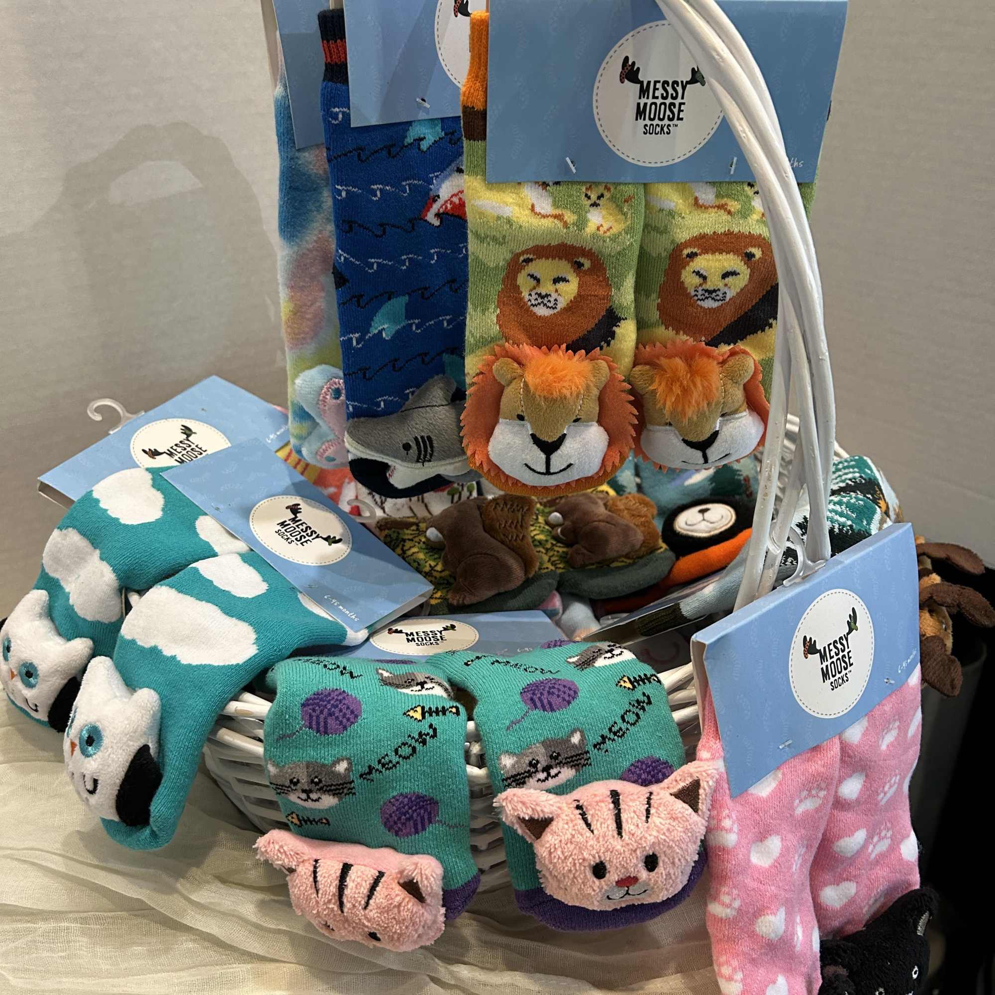 Basket of colorful animal-themed socks with blue tags