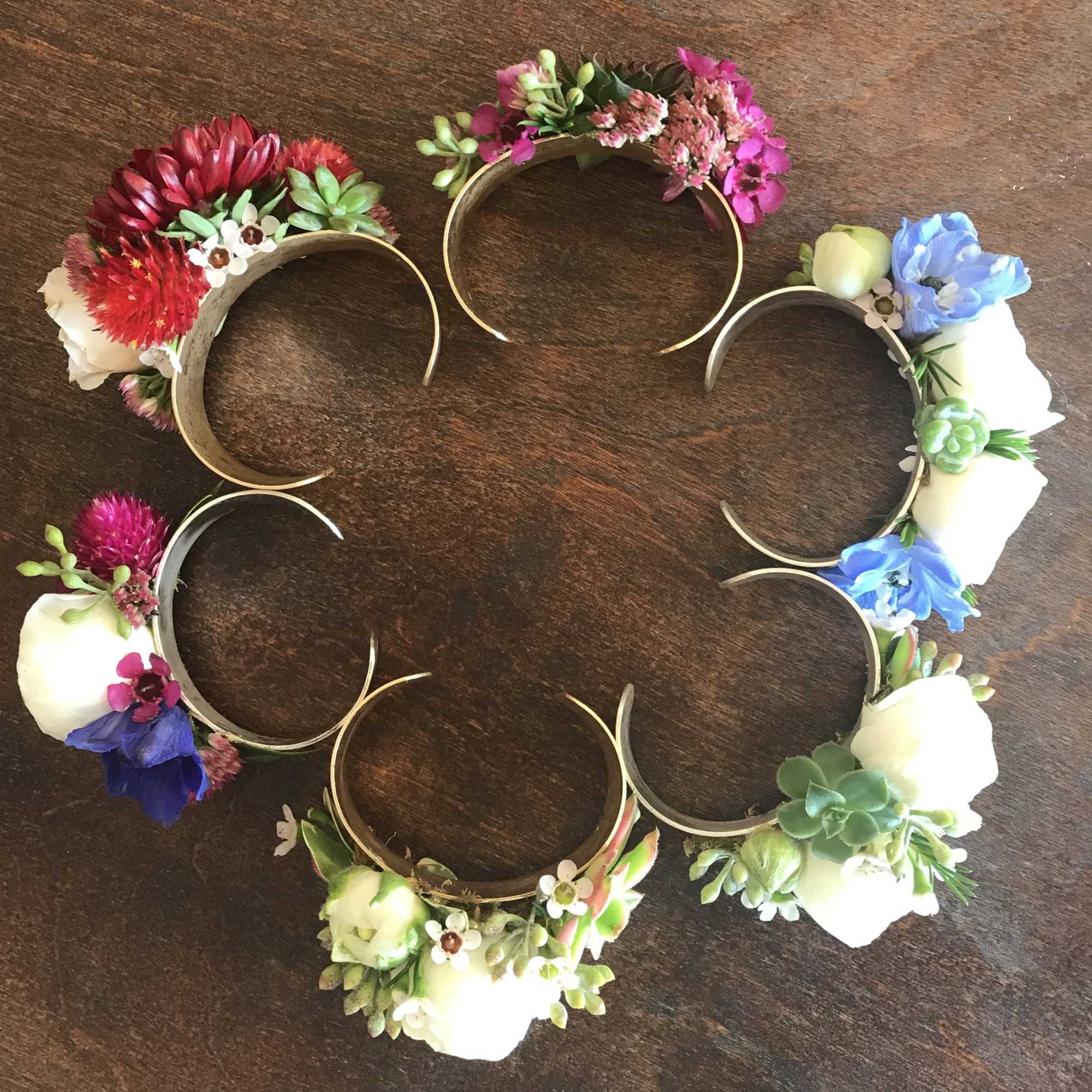 Cuff corsage featuring ranunculus with bits of foliage and other filler flowers., photo 3 of 4