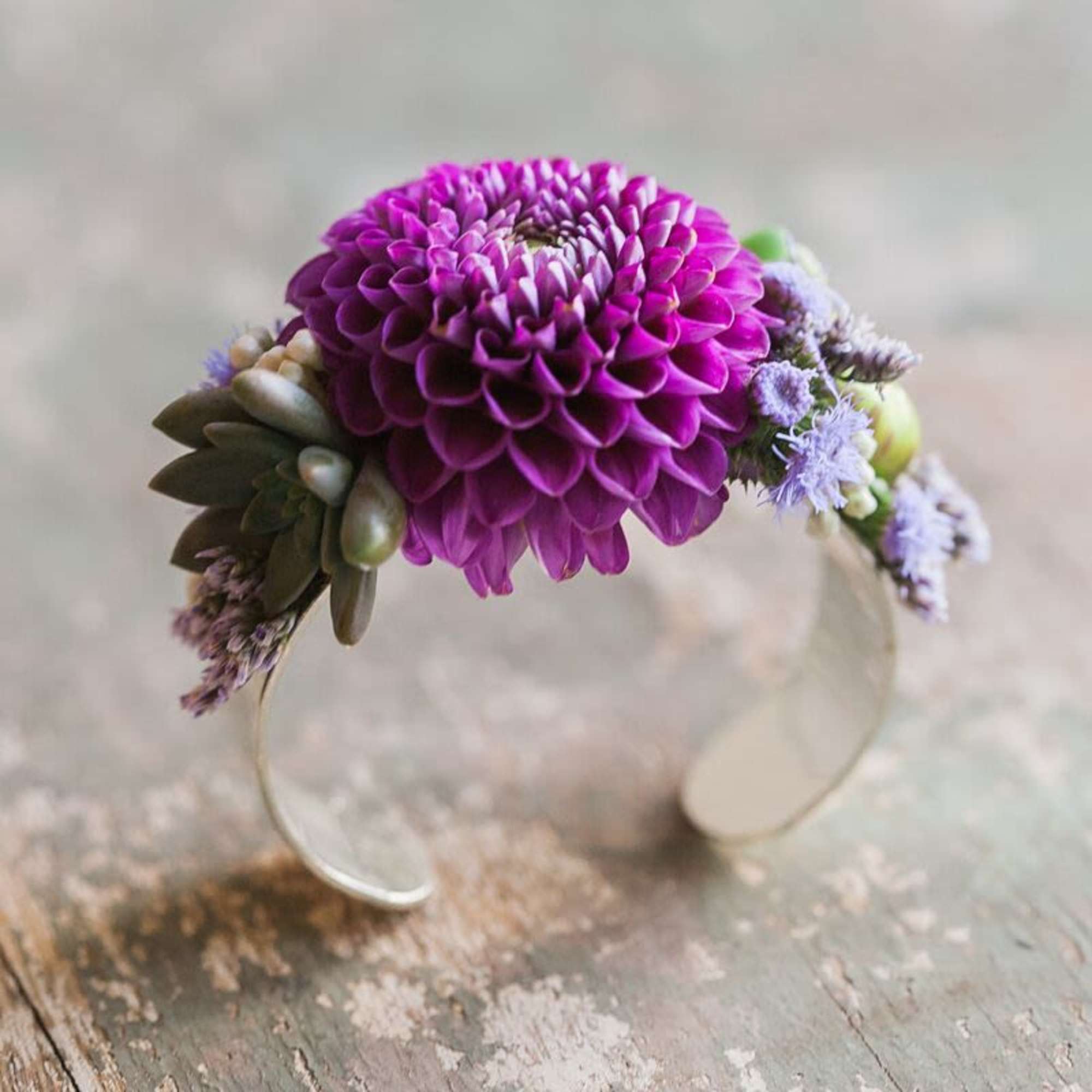 Cuff corsage featuring ranunculus with bits of foliage and other filler flowers., photo 4 of 4