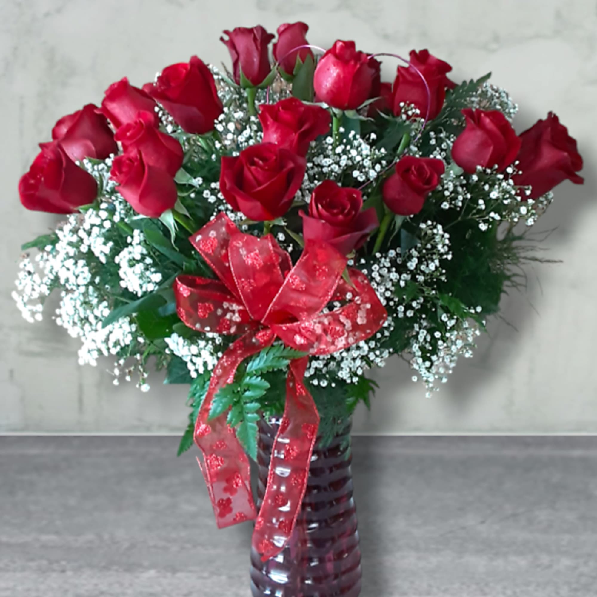 Timeless and romantic, this classic dozen of long-stemmed premium roses is the