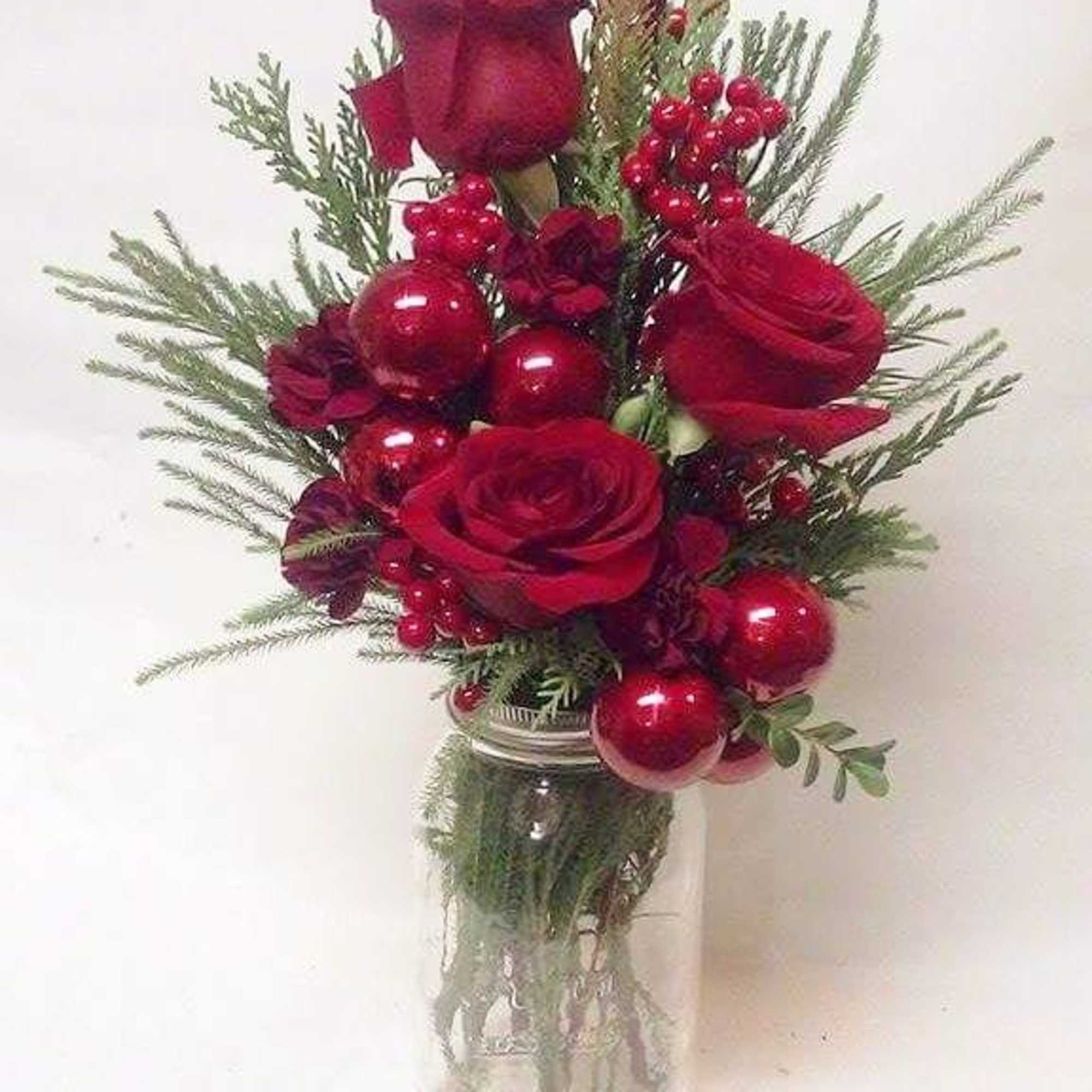 Red roses White Oriental lilies, Berries, Ornaments and seasonal greens in a