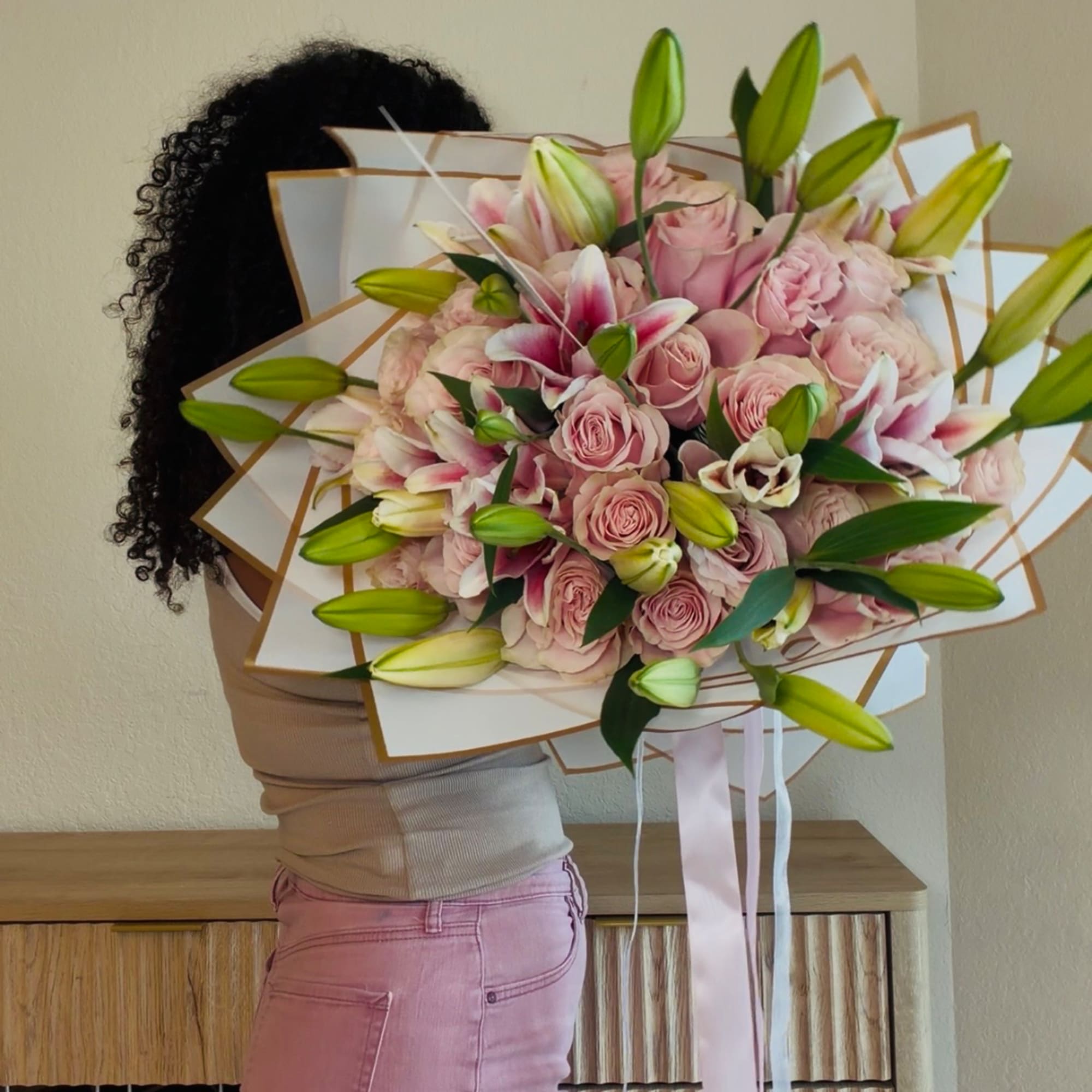 Large pink bouquet with lilies and roses wrapped in white paper