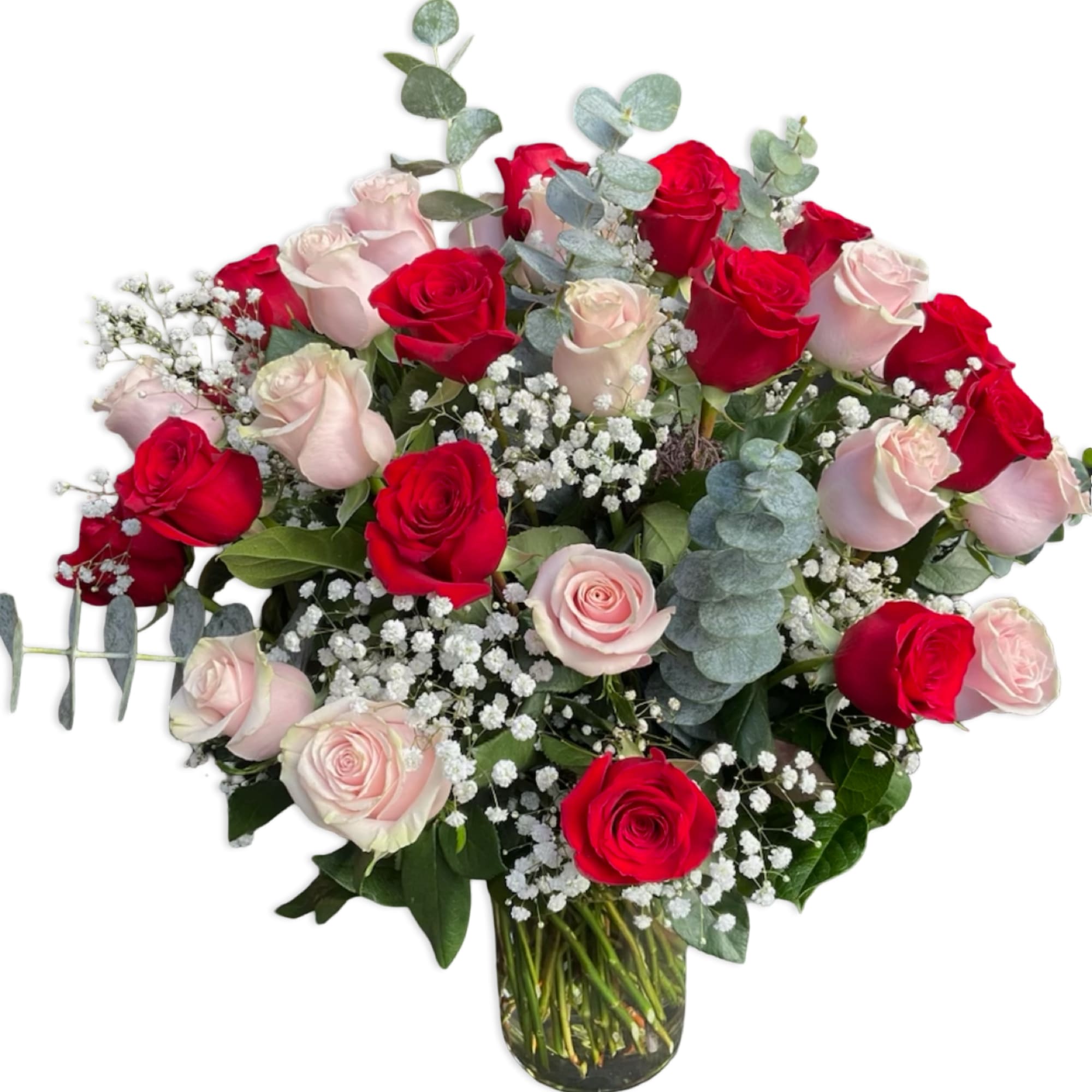 Bouquet of red and pale pink roses in a glass vase
