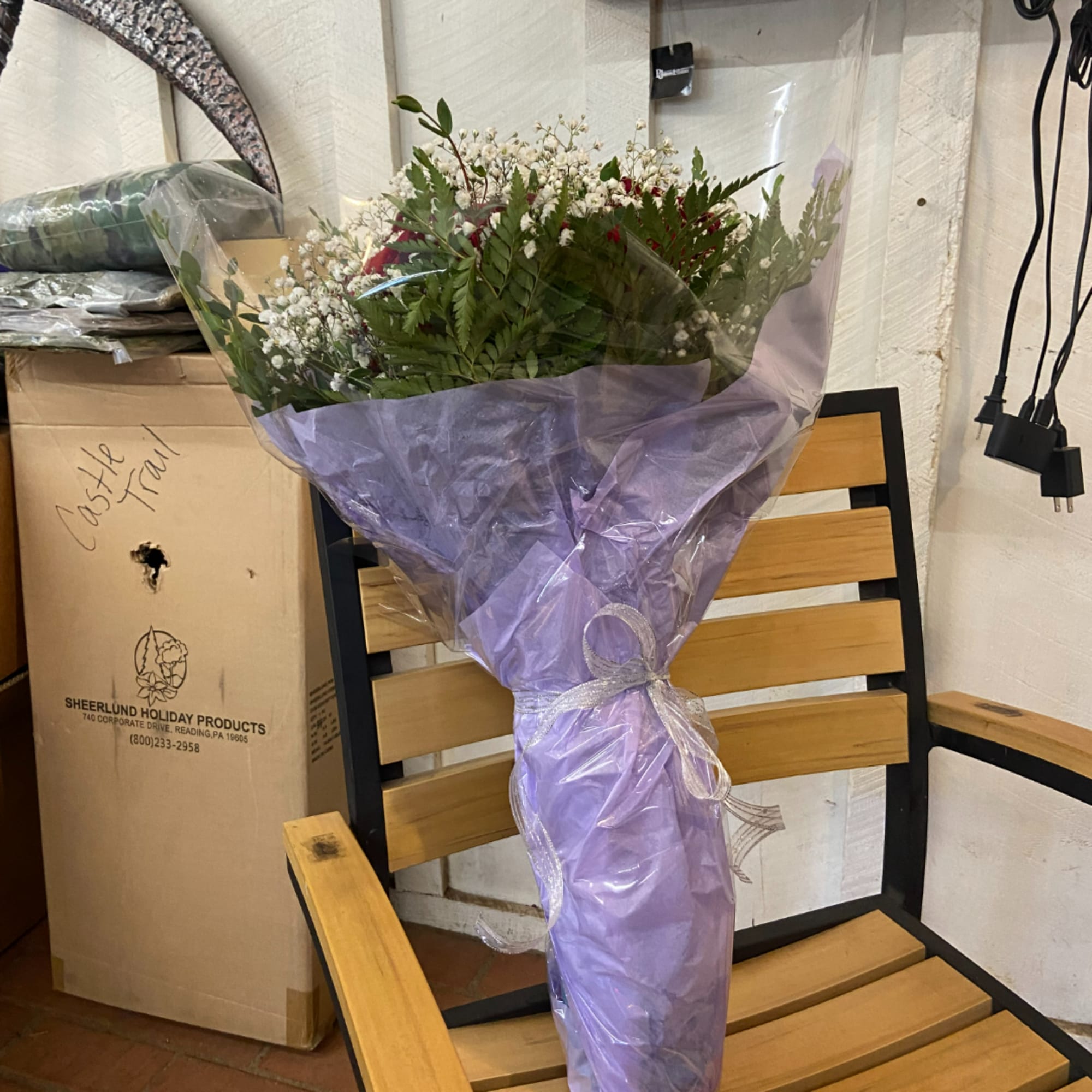 Wrapped bouquet of red flowers and white baby's breath