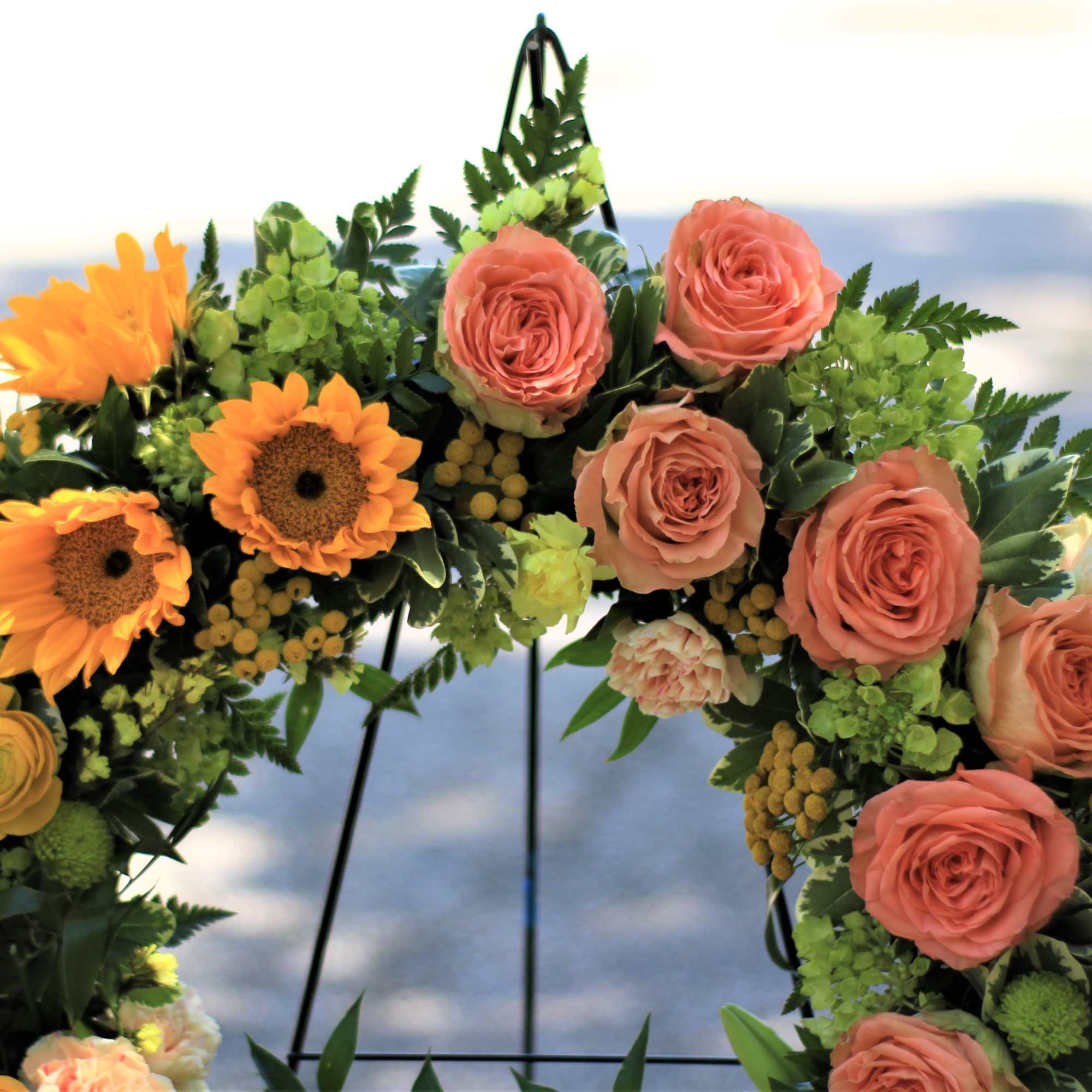Floral wreath with peach roses and orange sunflowers