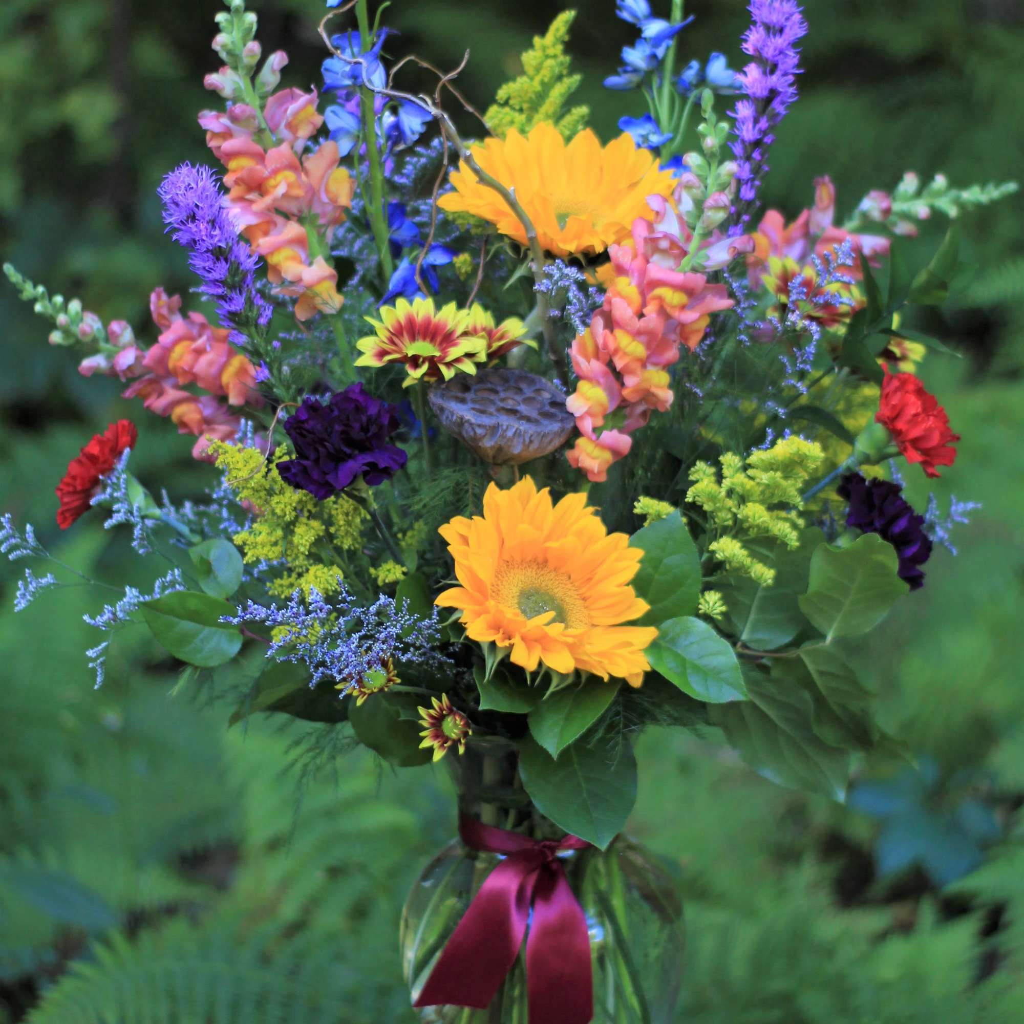 Mixed bouquet in a glass vase with bright yellow and purple flowers