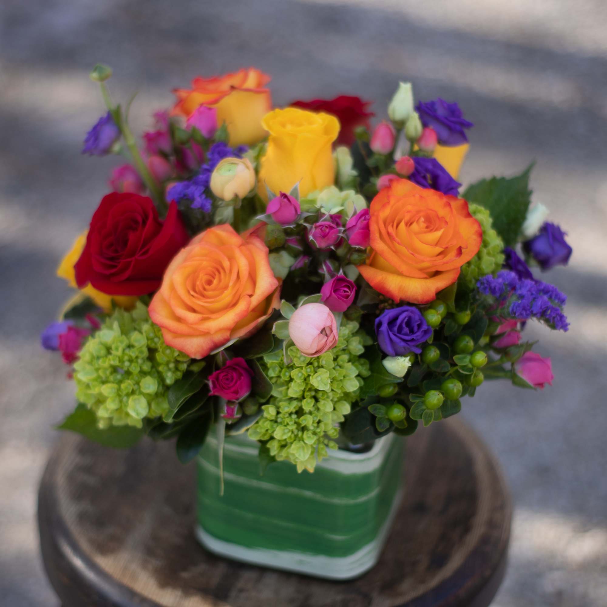 Colorful rose bouquet in a green square container