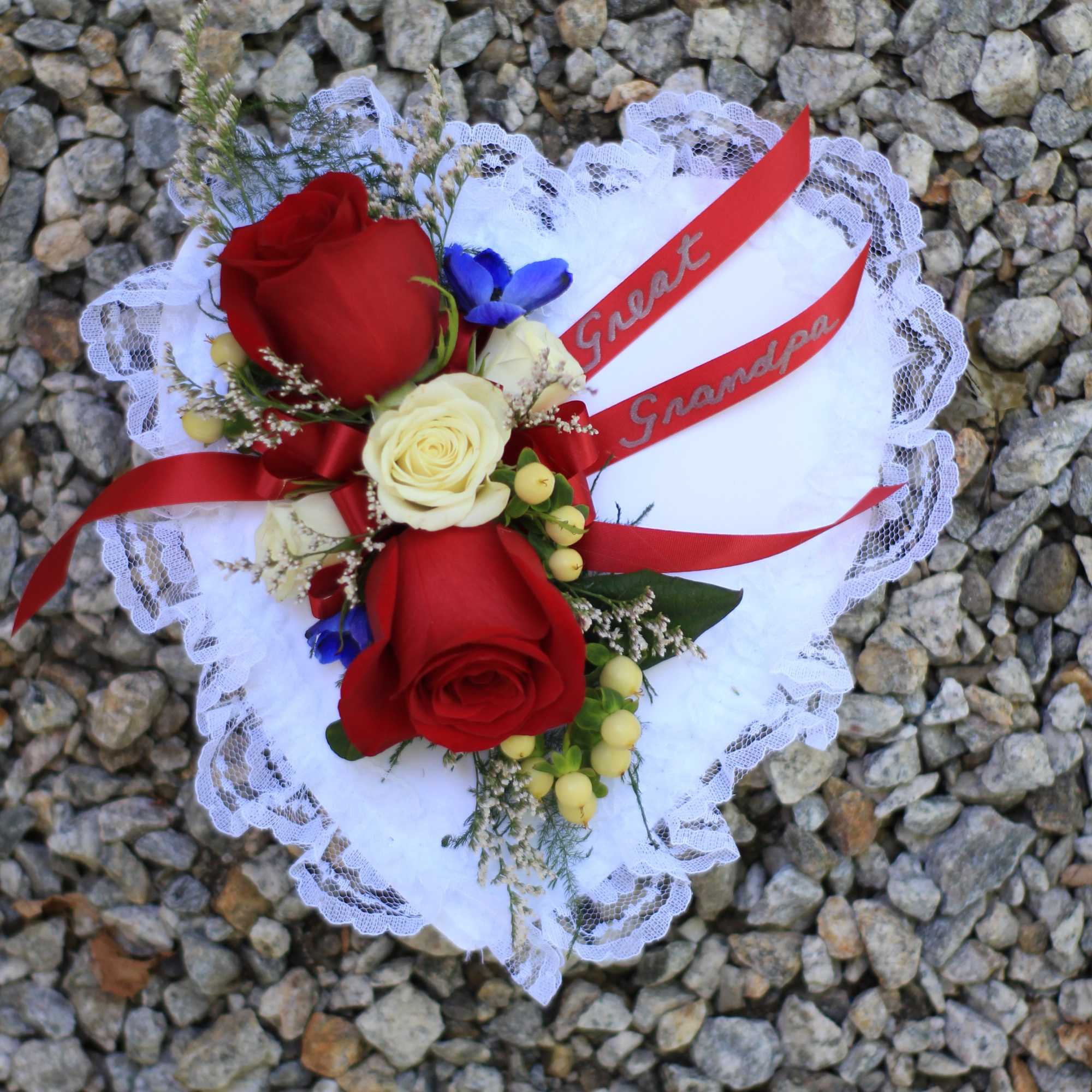 Red and white rose bouquet with lace wrap and red ribbons