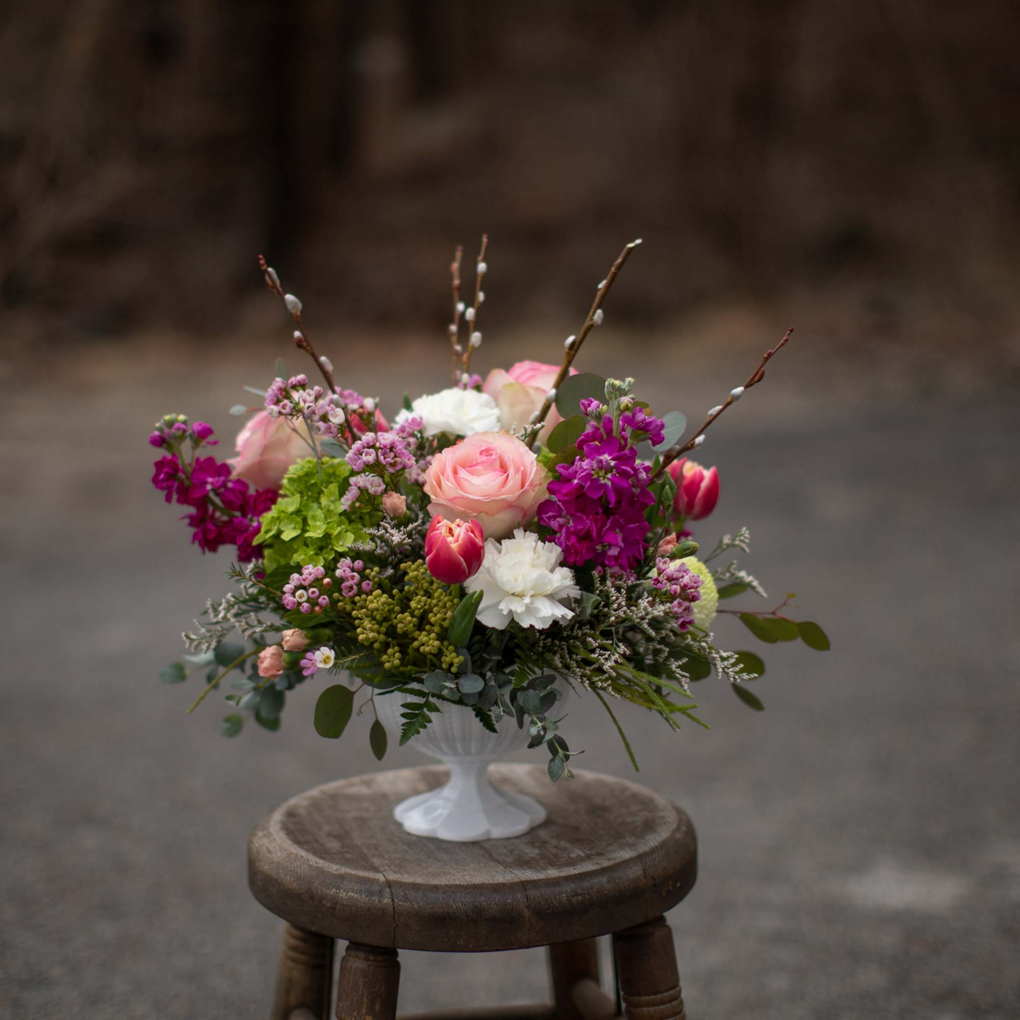 Pink and white floral arrangement in a white pedestal vase, photo 6 of 7