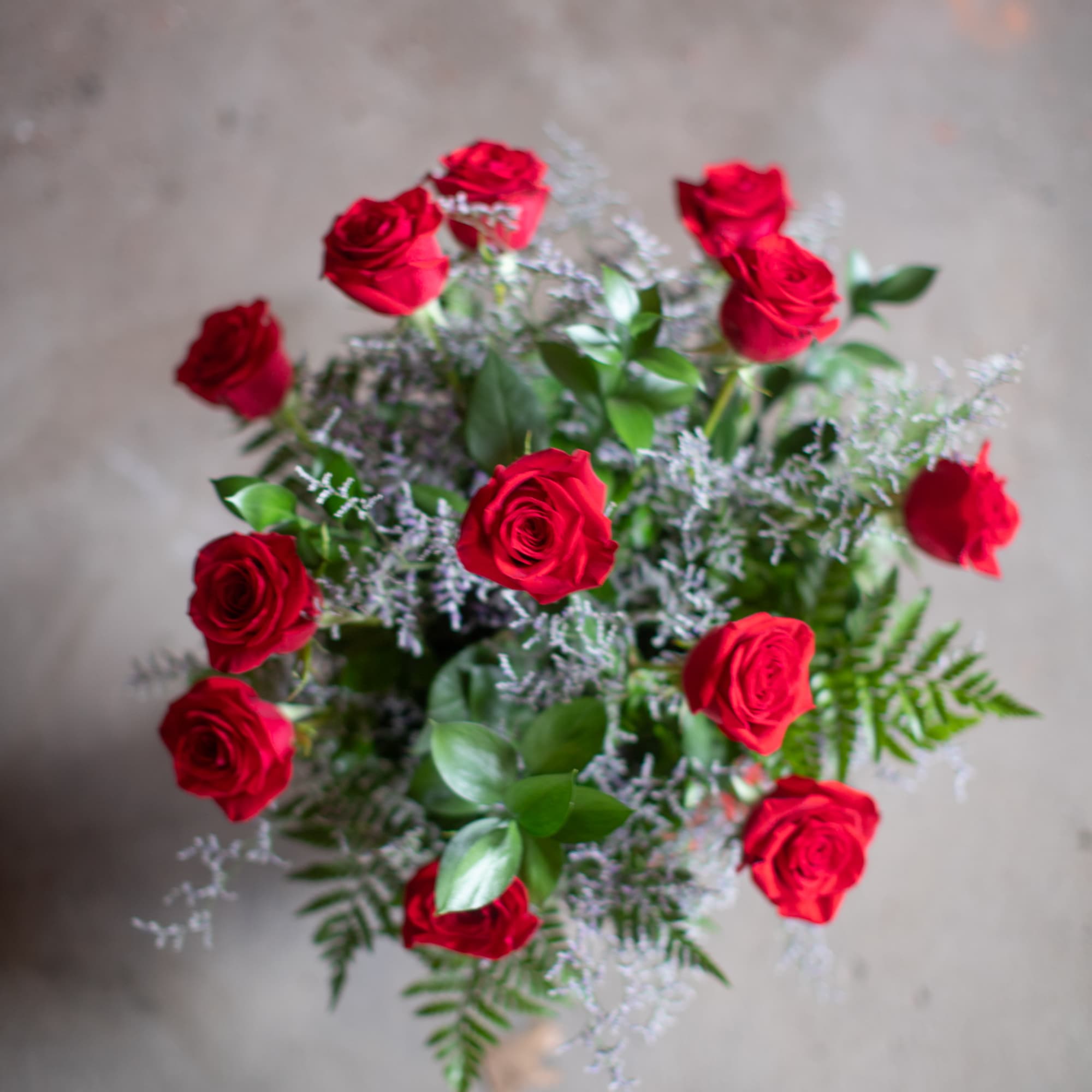 Bouquet of red roses with mixed greenery