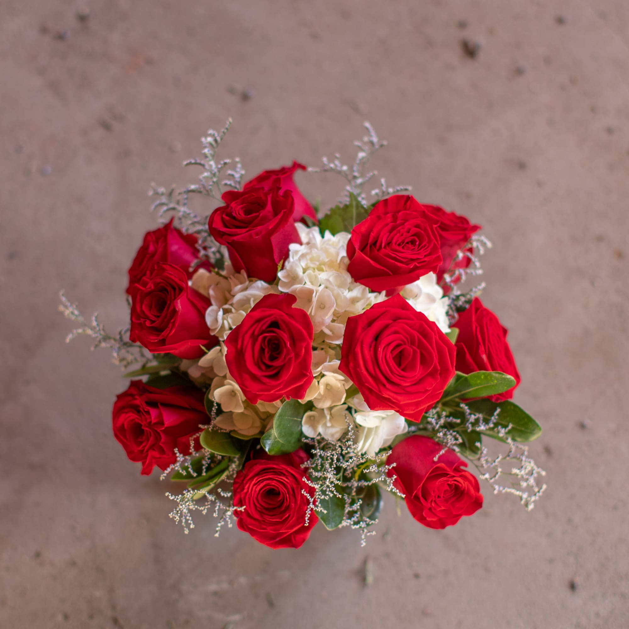 Bouquet of red roses with white hydrangeas and greenery