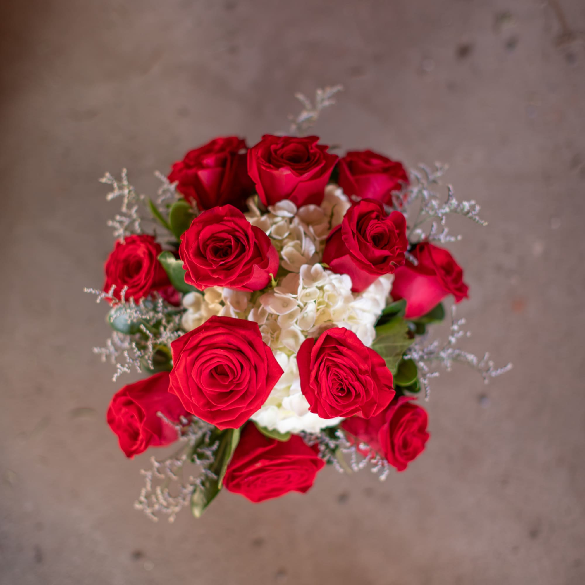 Bouquet of red roses with white hydrangeas and silver filler