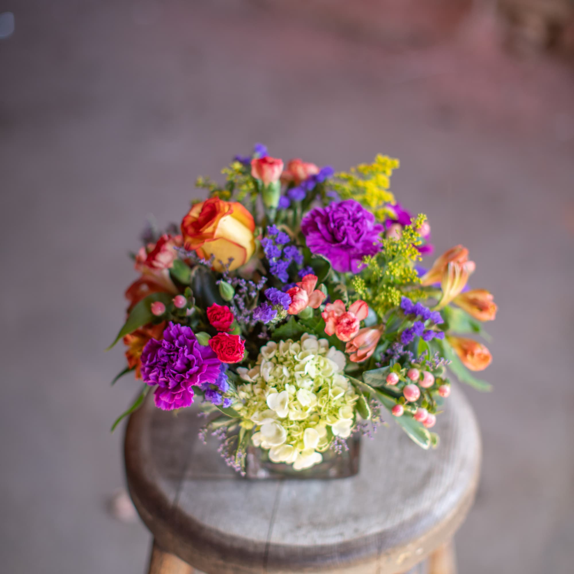 Colorful mixed bouquet with roses, carnations, hydrangea, and small filler flowers