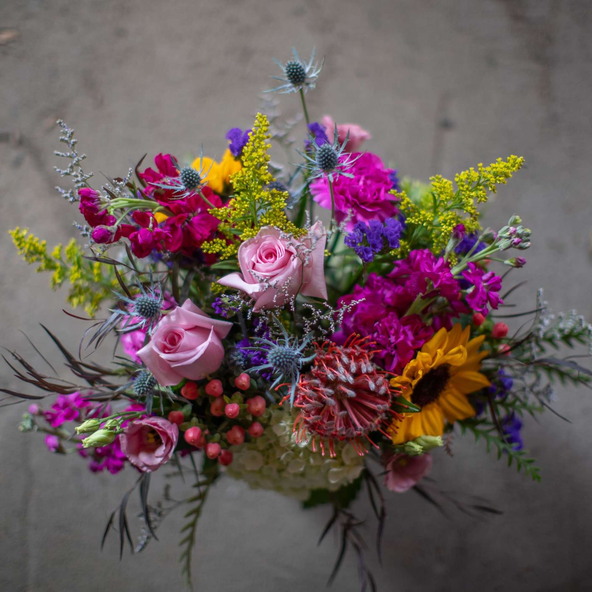 Colorful mixed bouquet with pink roses and a sunflower