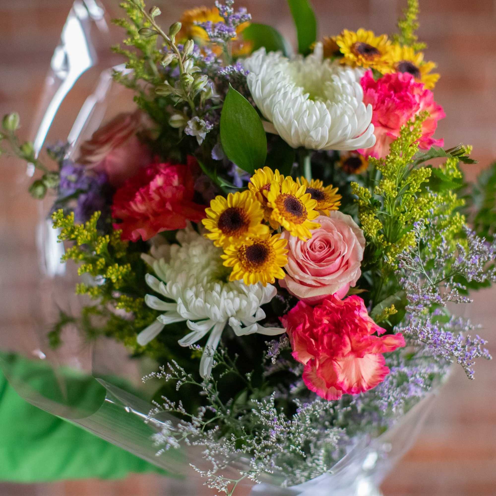 Mixed bouquet with pink roses, white chrysanthemums, and yellow daisies
