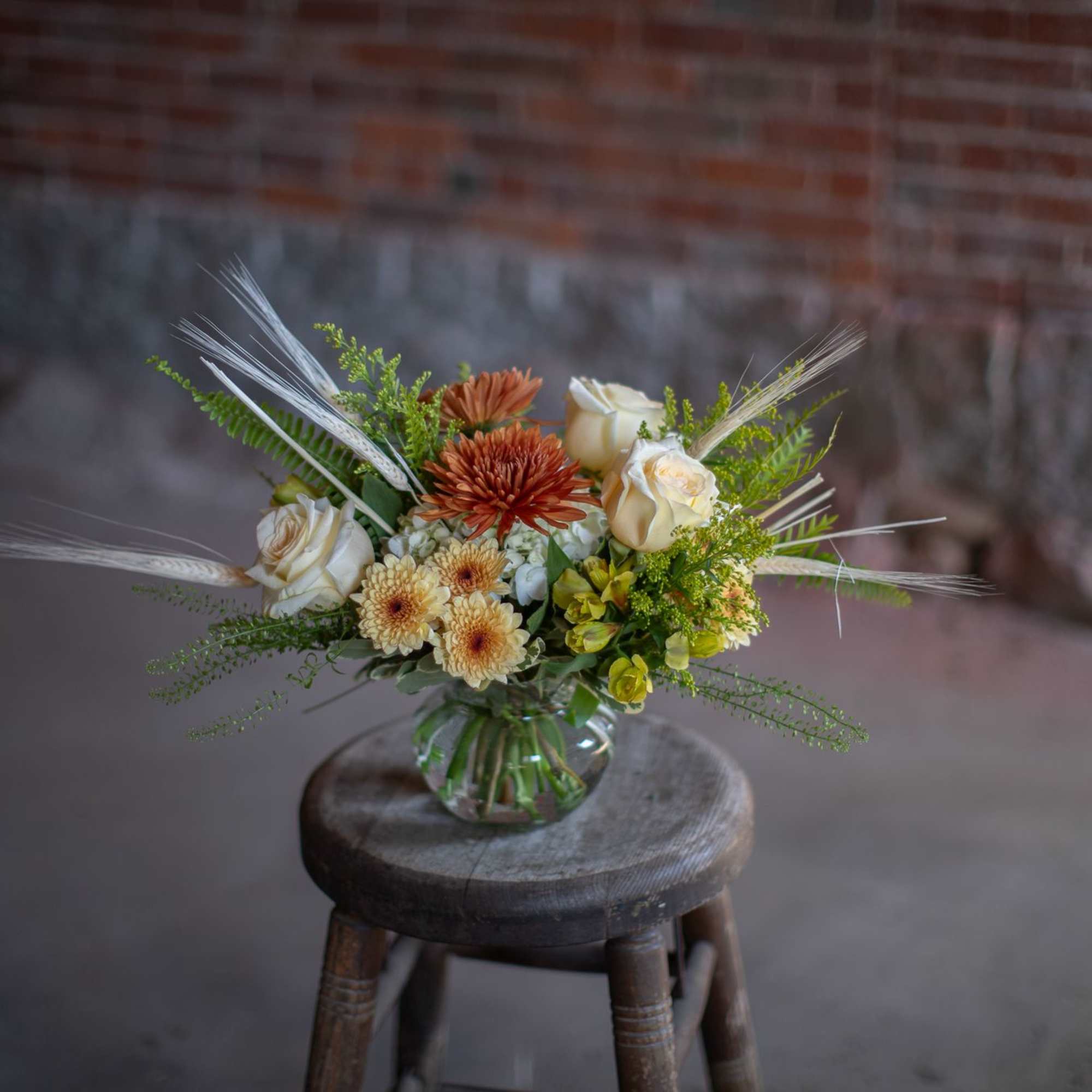 Wonderful bleached wheat whisps from pretty vintage-toned fall blooms in a shallow