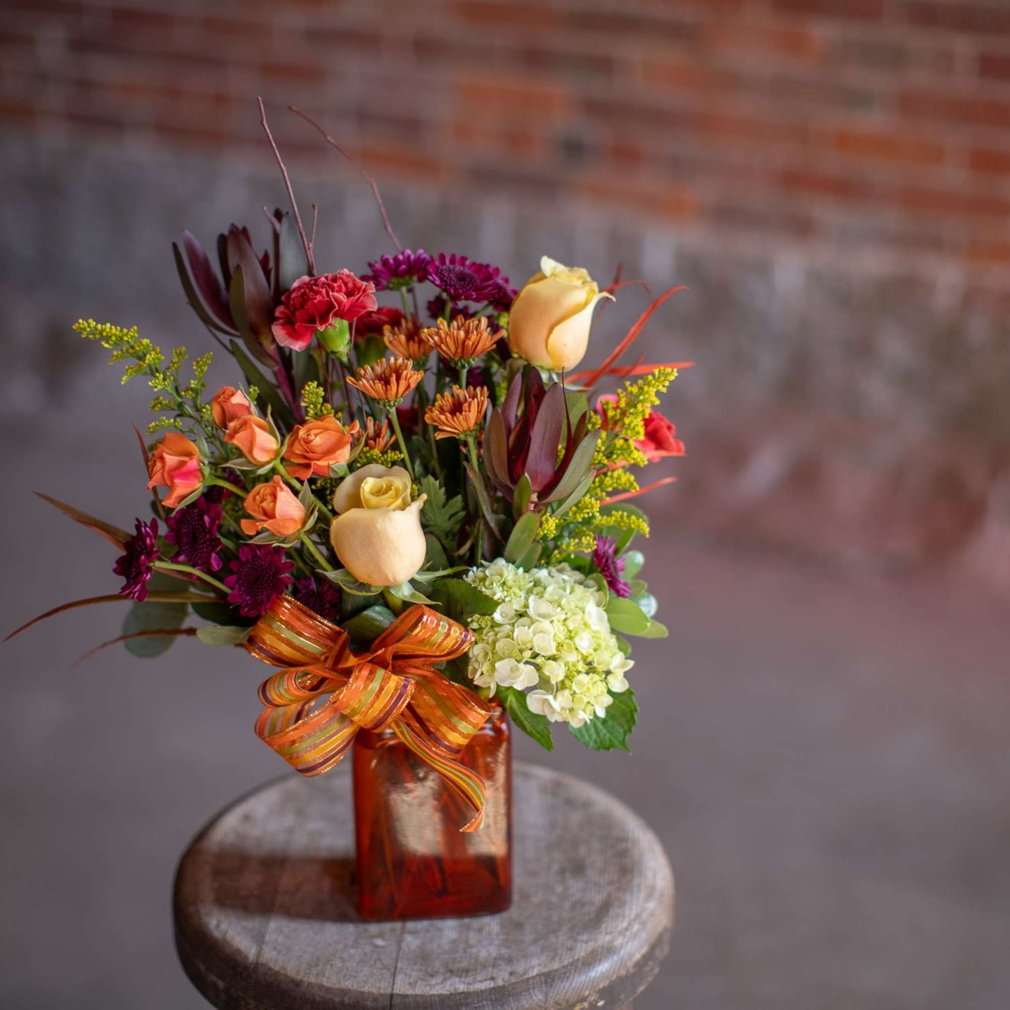 A rectangular shaped vase in an autumnal hue (orange, green, rust, or, photo 2 of 3