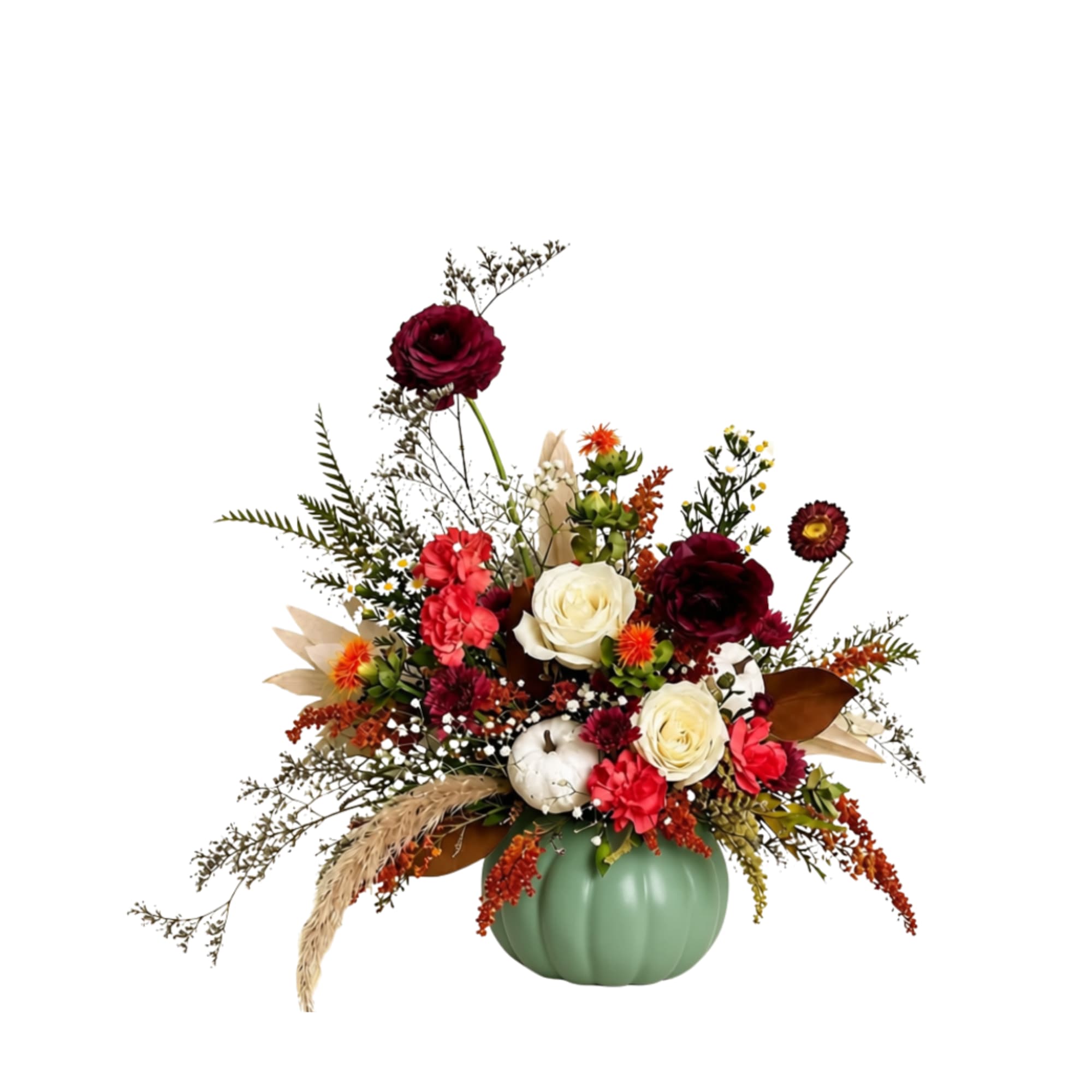 Fall floral arrangement in a green pumpkin vase with red, cream, and orange blooms