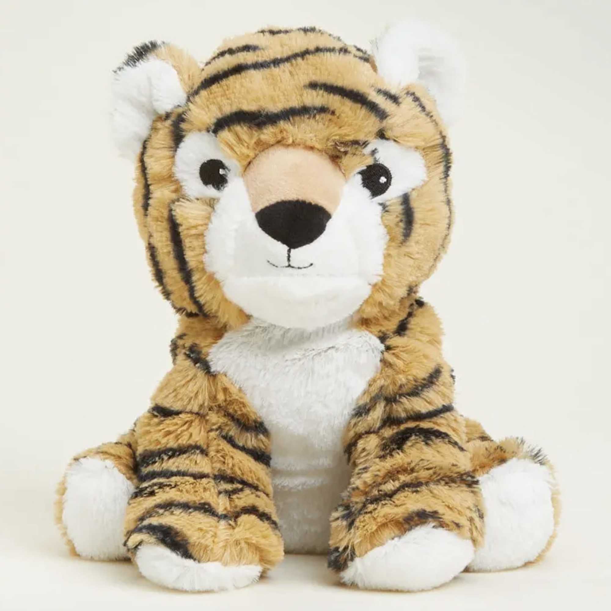 Plush tiger stuffed animal sitting against a plain background