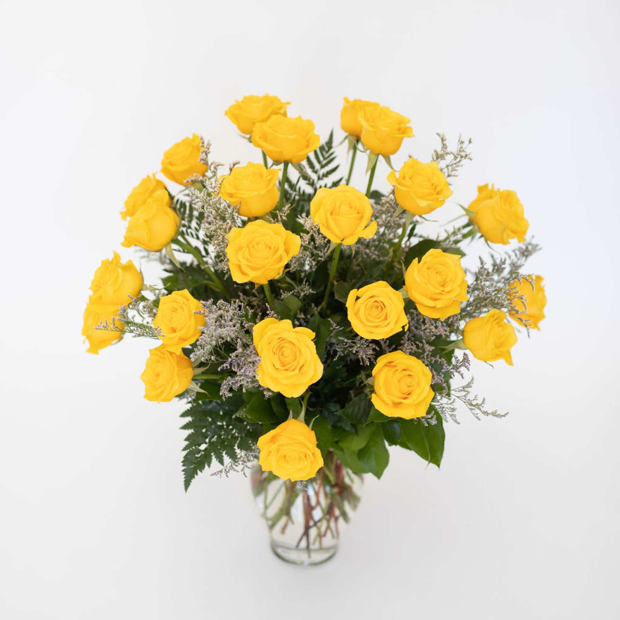 Yellow roses arranged in a clear glass vase