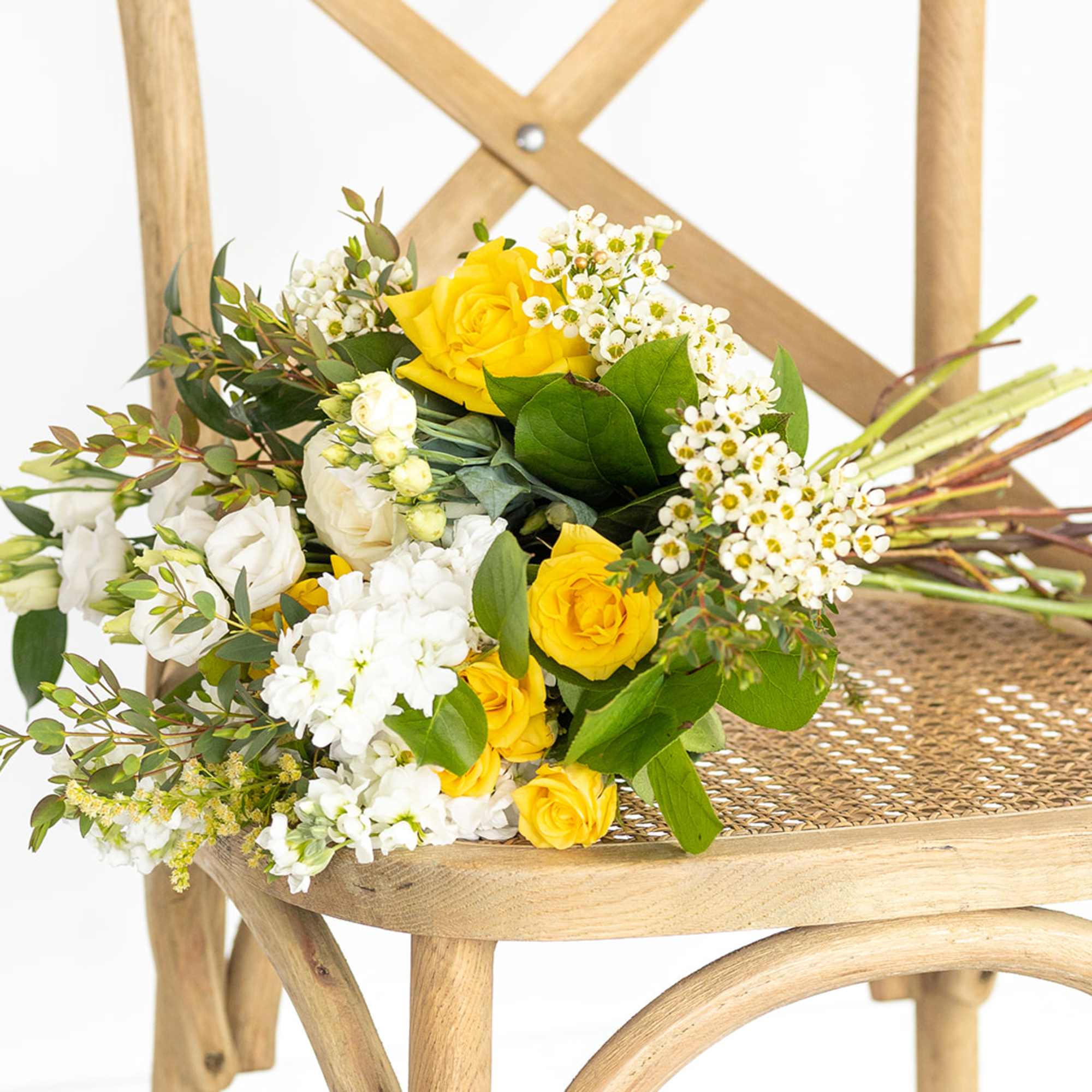 Yellow and white rose bouquet with small white filler flowers