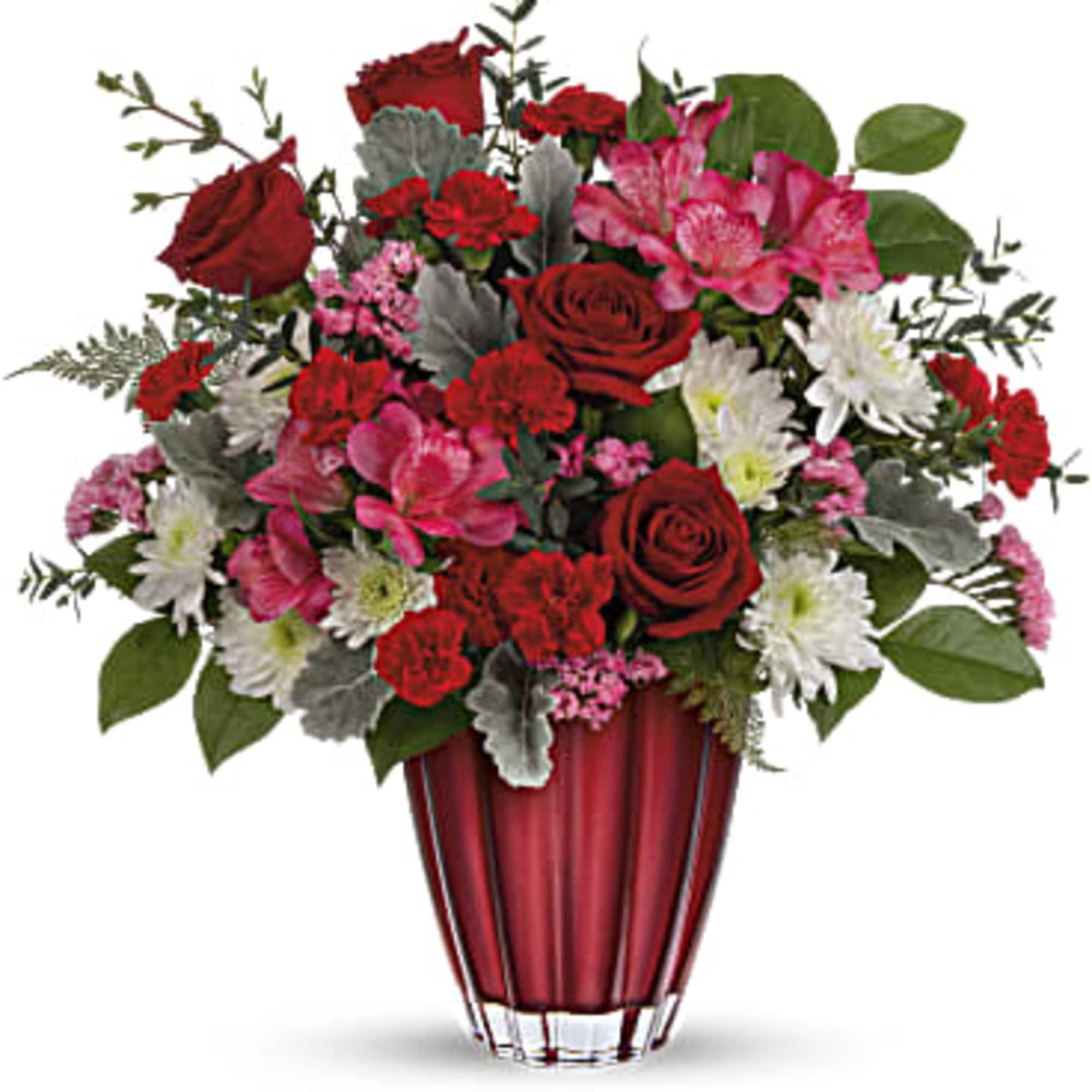 Red roses and pink flowers arranged in a red vase