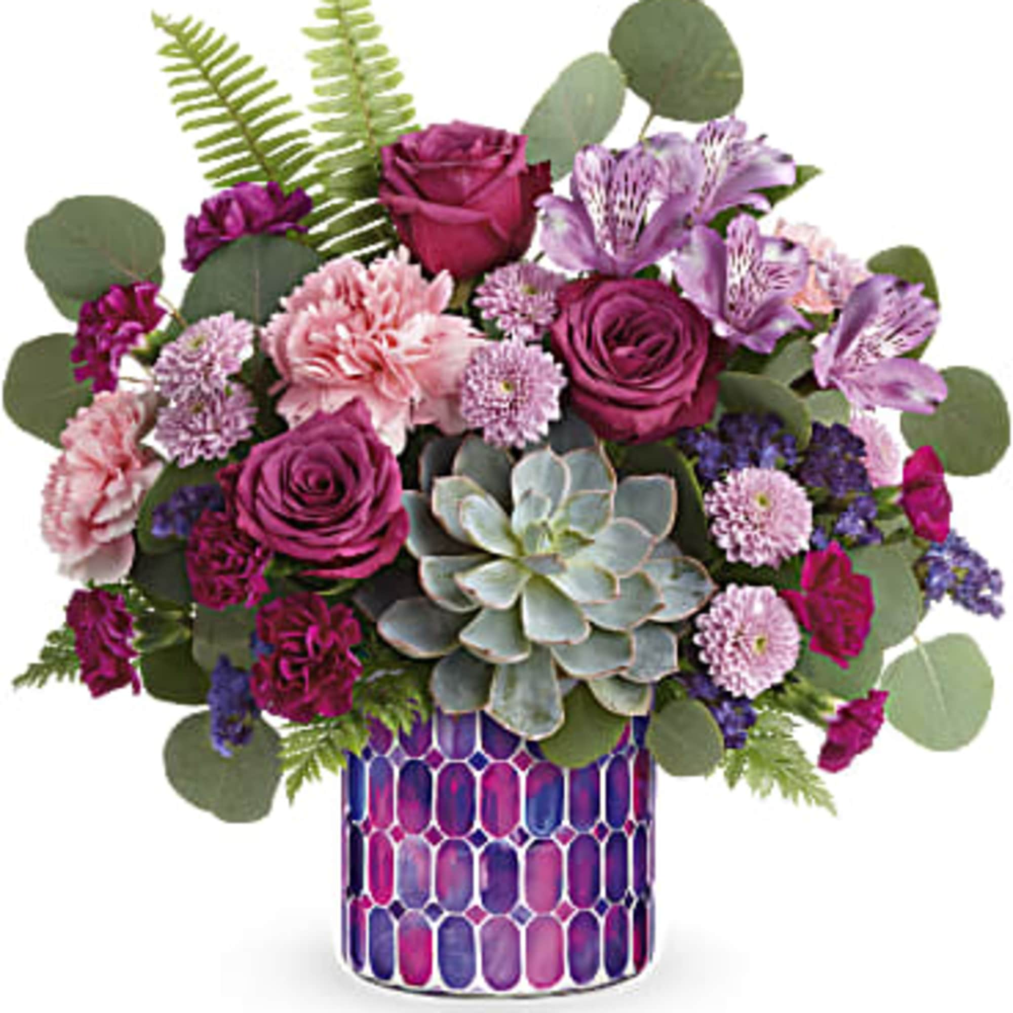 Purple and pink floral arrangement in a patterned vase with a succulent