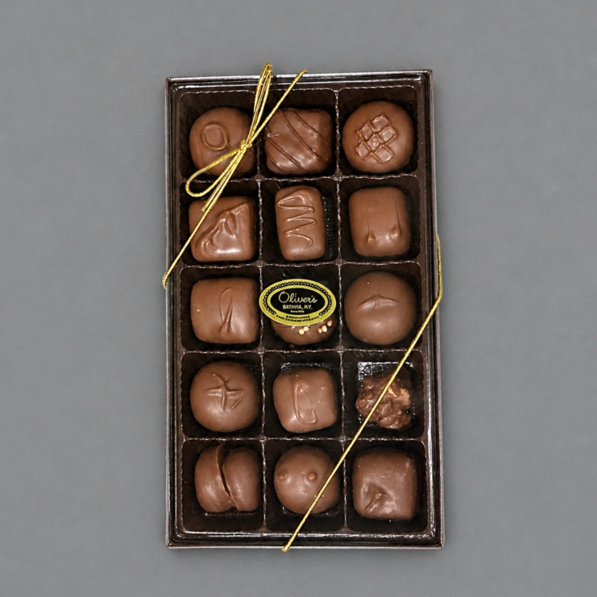 Box of assorted chocolates tied with a gold ribbon