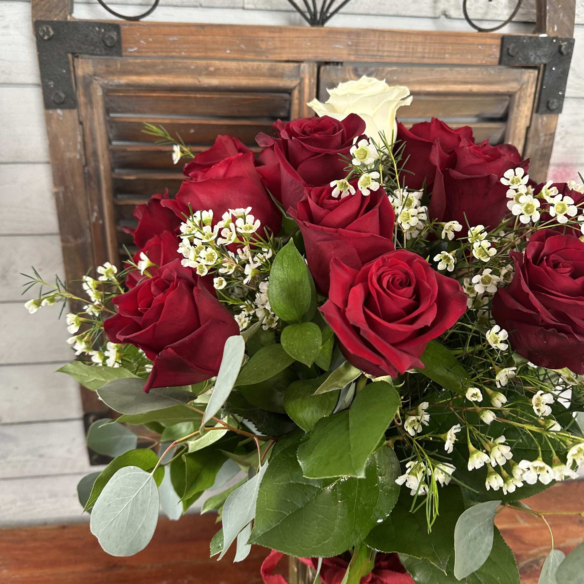 Bouquet of red and white roses with small white filler flowers, photo 3 of 3