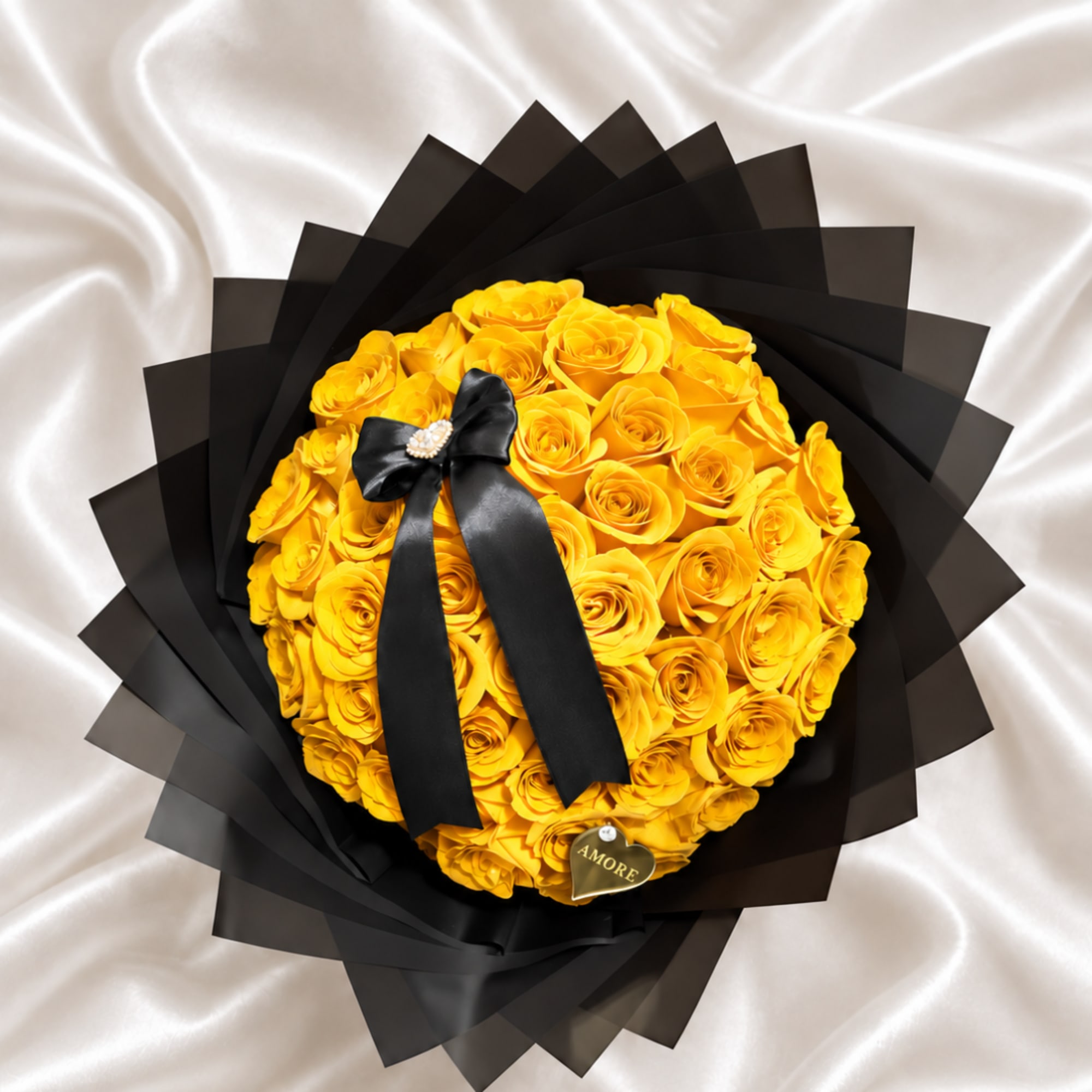 Yellow rose bouquet wrapped in black paper with a black ribbon