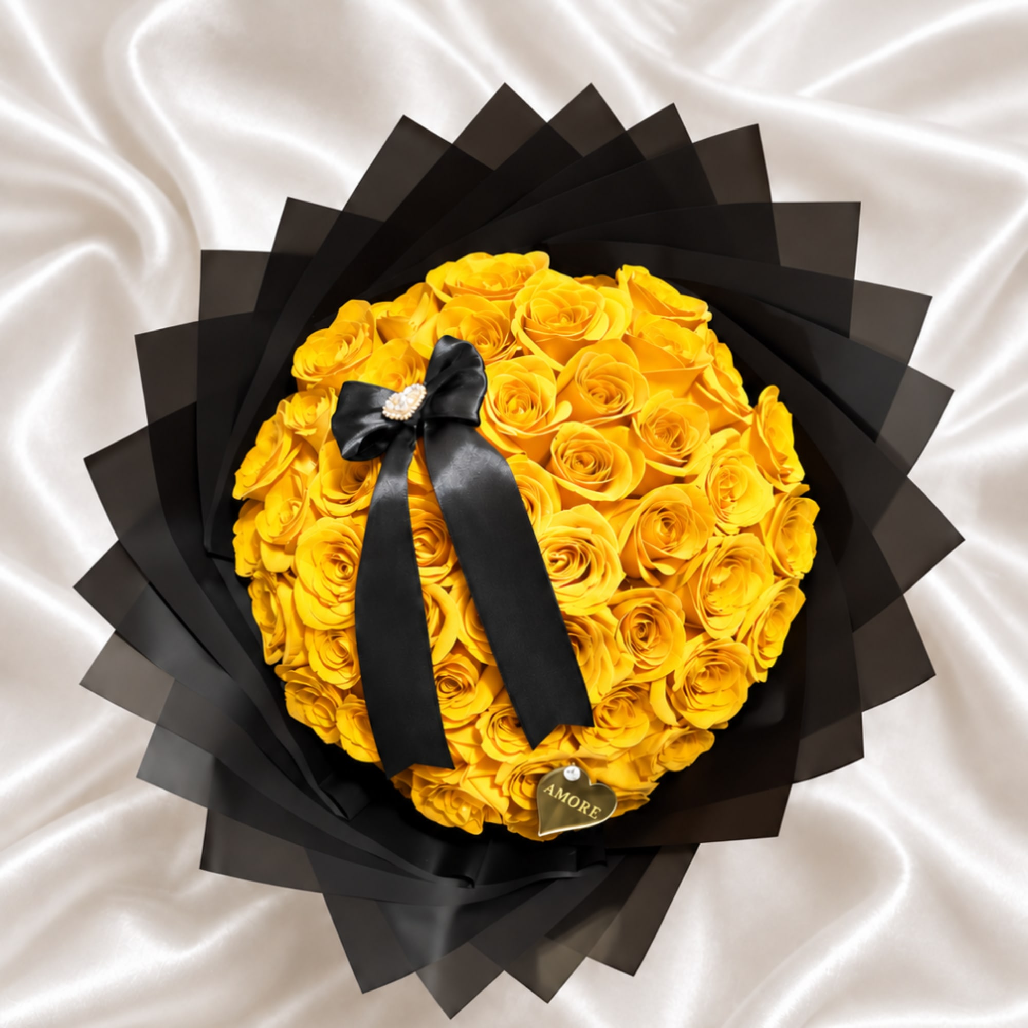 Yellow rose bouquet wrapped in black paper with a black ribbon