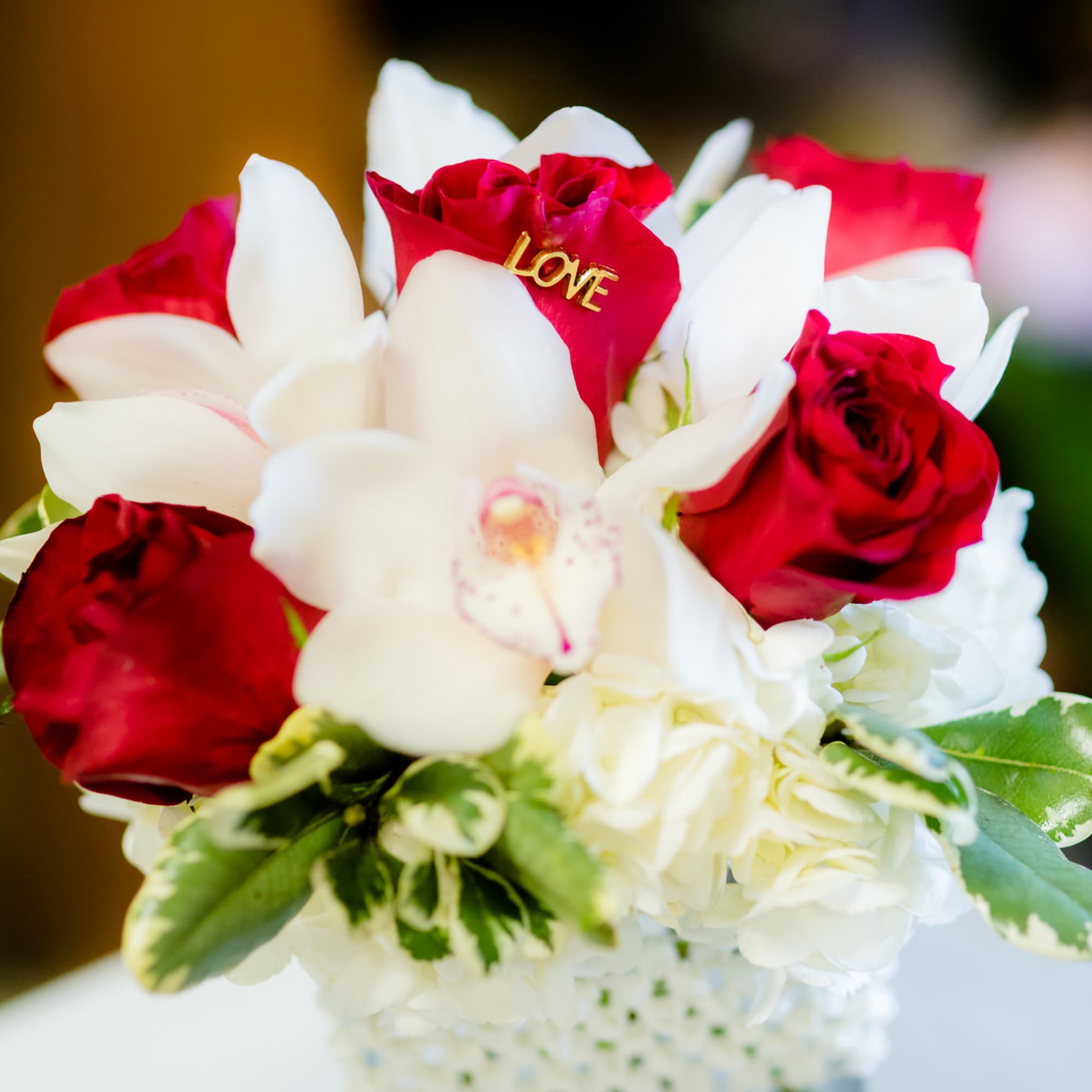 Red and white rose bouquet with orchids and hydrangea