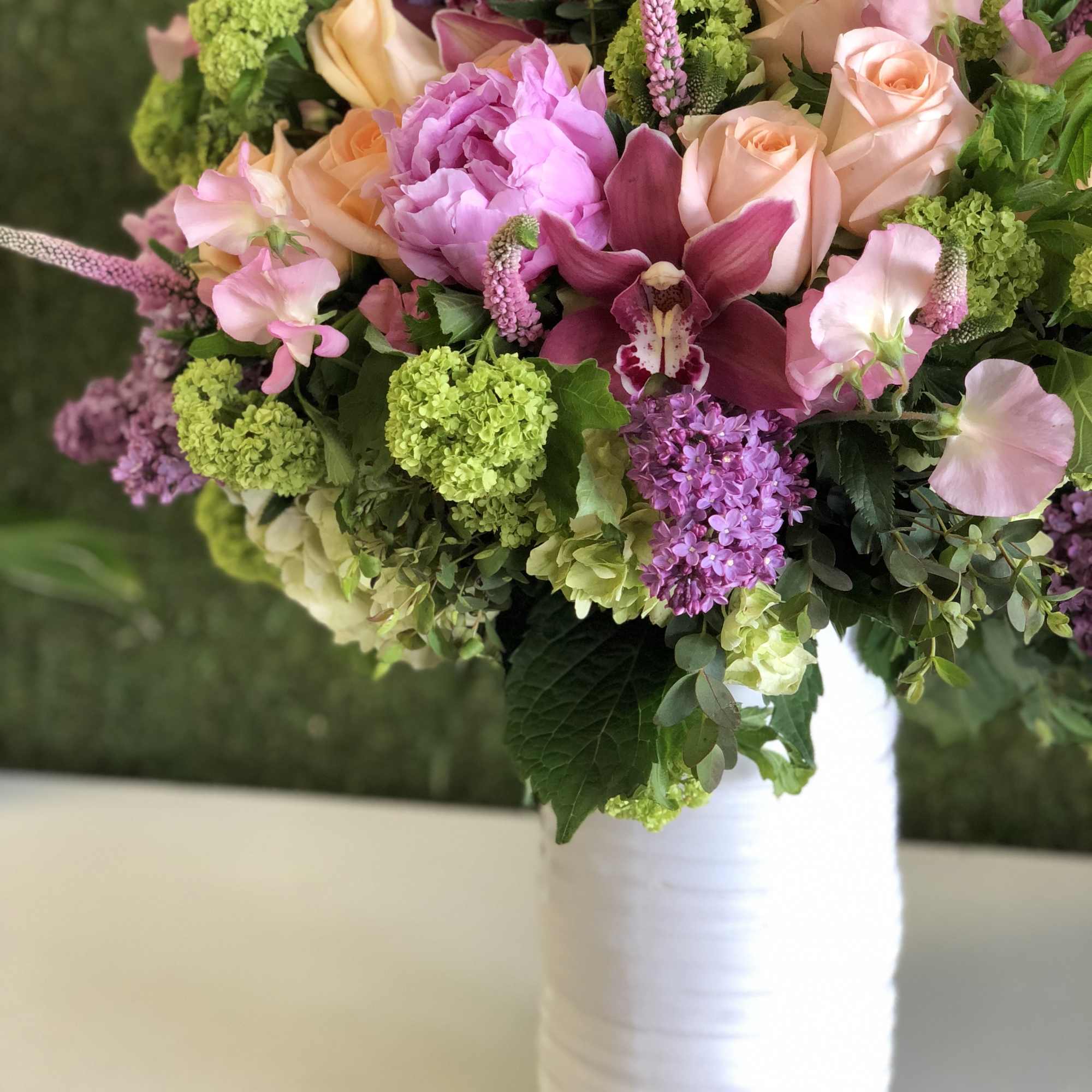 Bouquet of pink and peach flowers in a white vase, photo 2 of 4