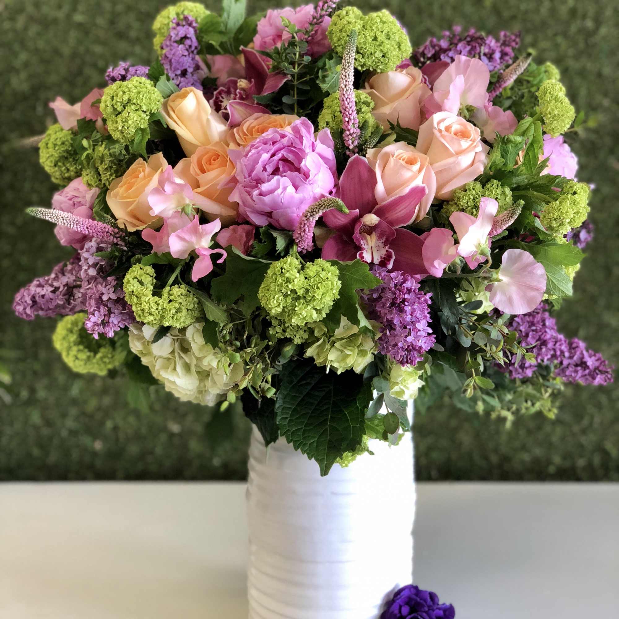 Bouquet of pink and peach flowers in a white vase