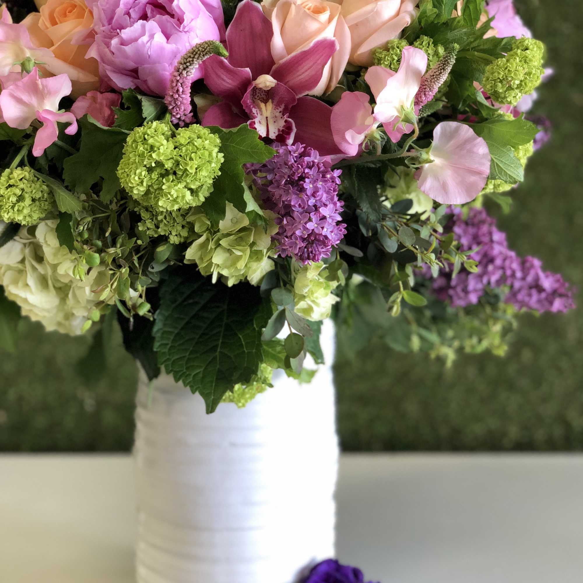 Pink and peach bouquet in a white vase