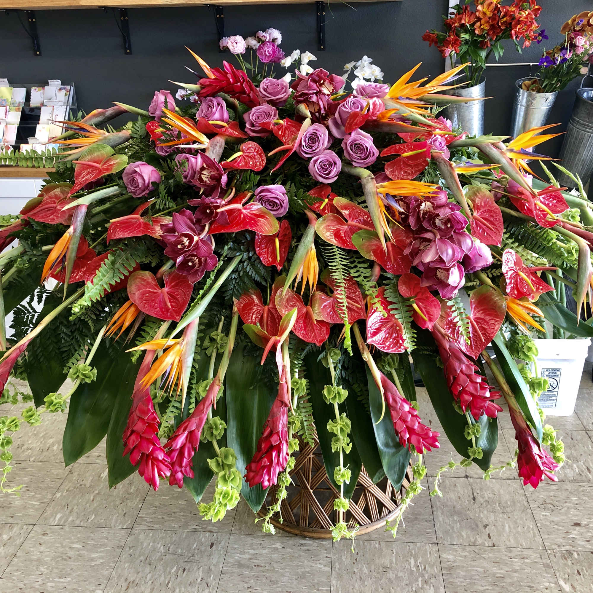 Large tropical floral arrangement in a woven basket