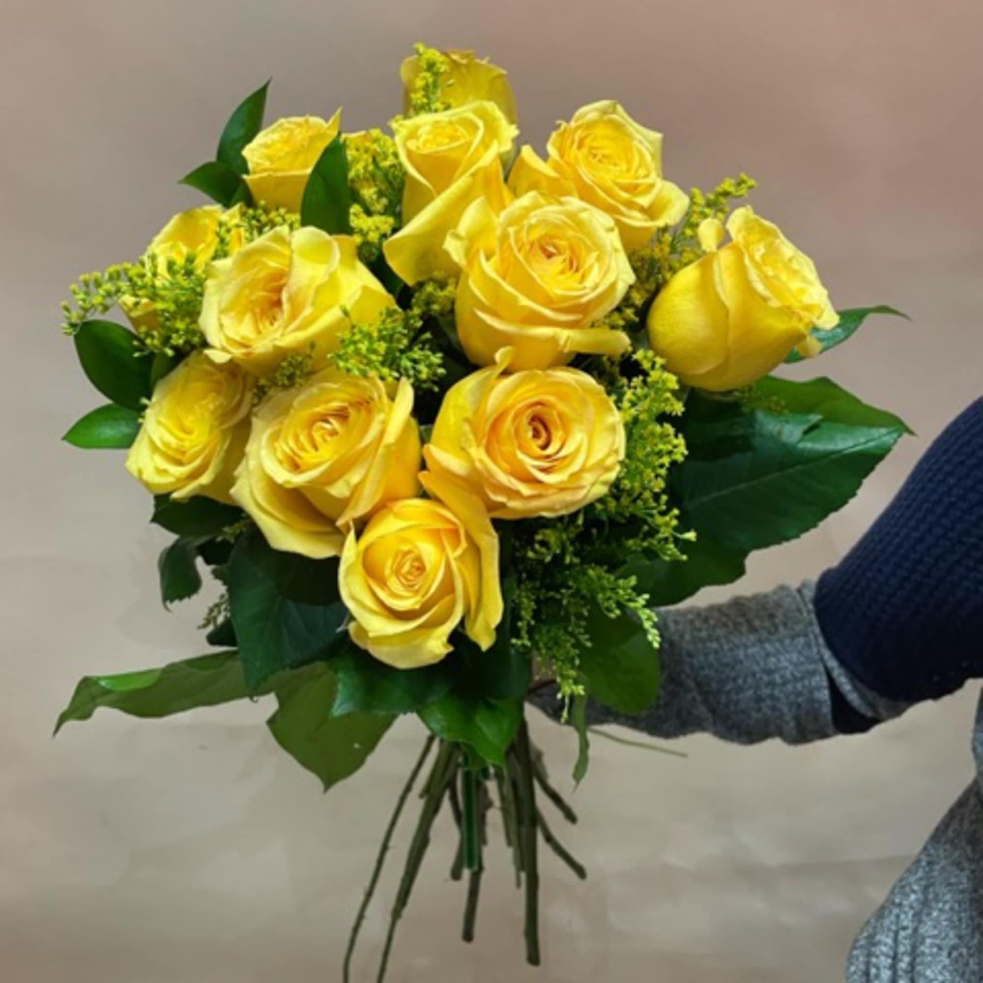 Bouquet of yellow roses with green filler