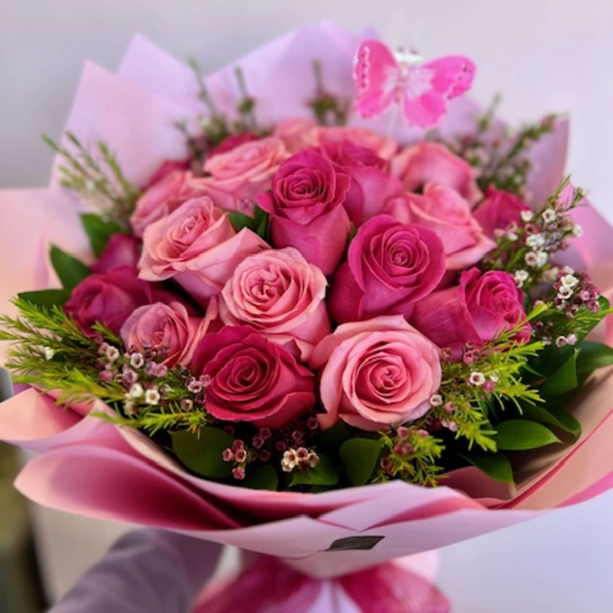 Pink and red rose bouquet wrapped in pink paper