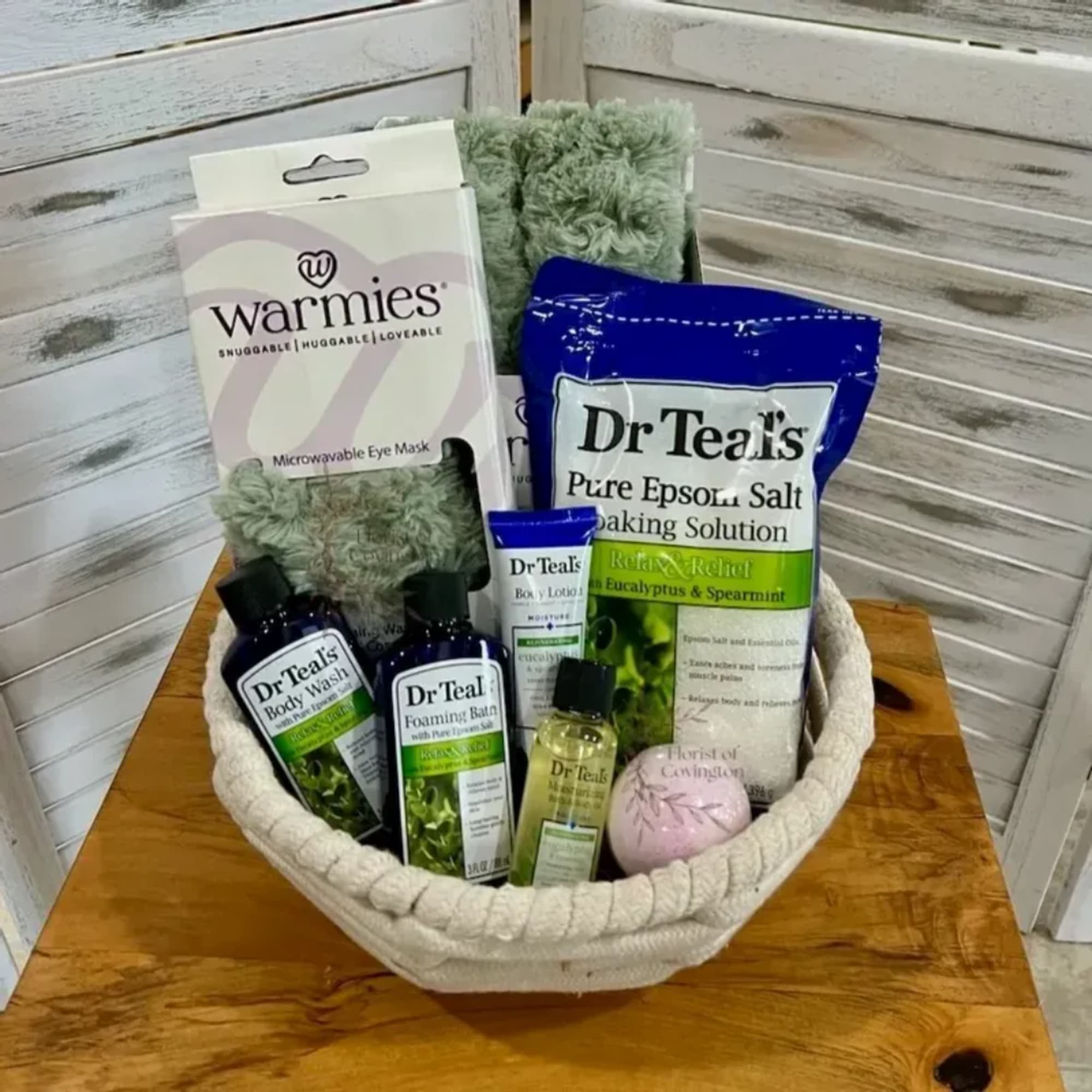 Spa gift basket with bath products and a microwavable eye mask