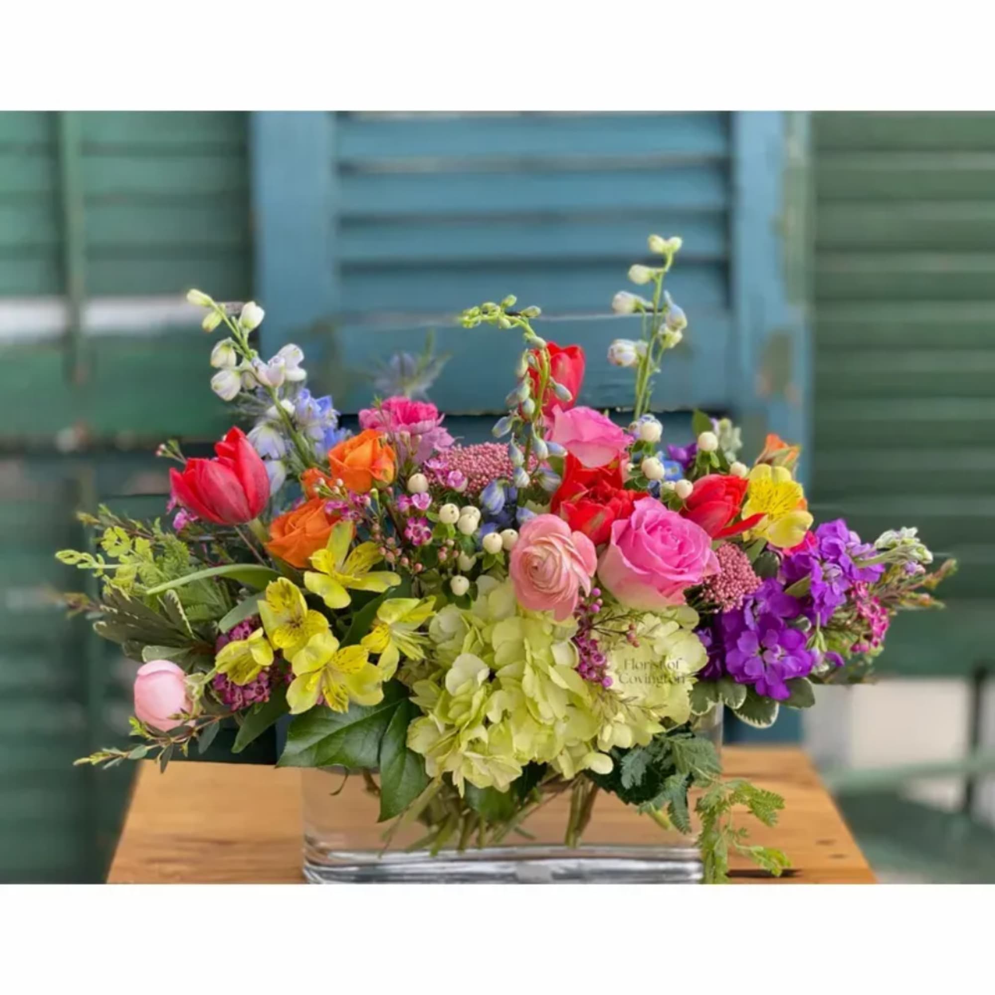 Colorful mixed bouquet in a clear rectangular vase