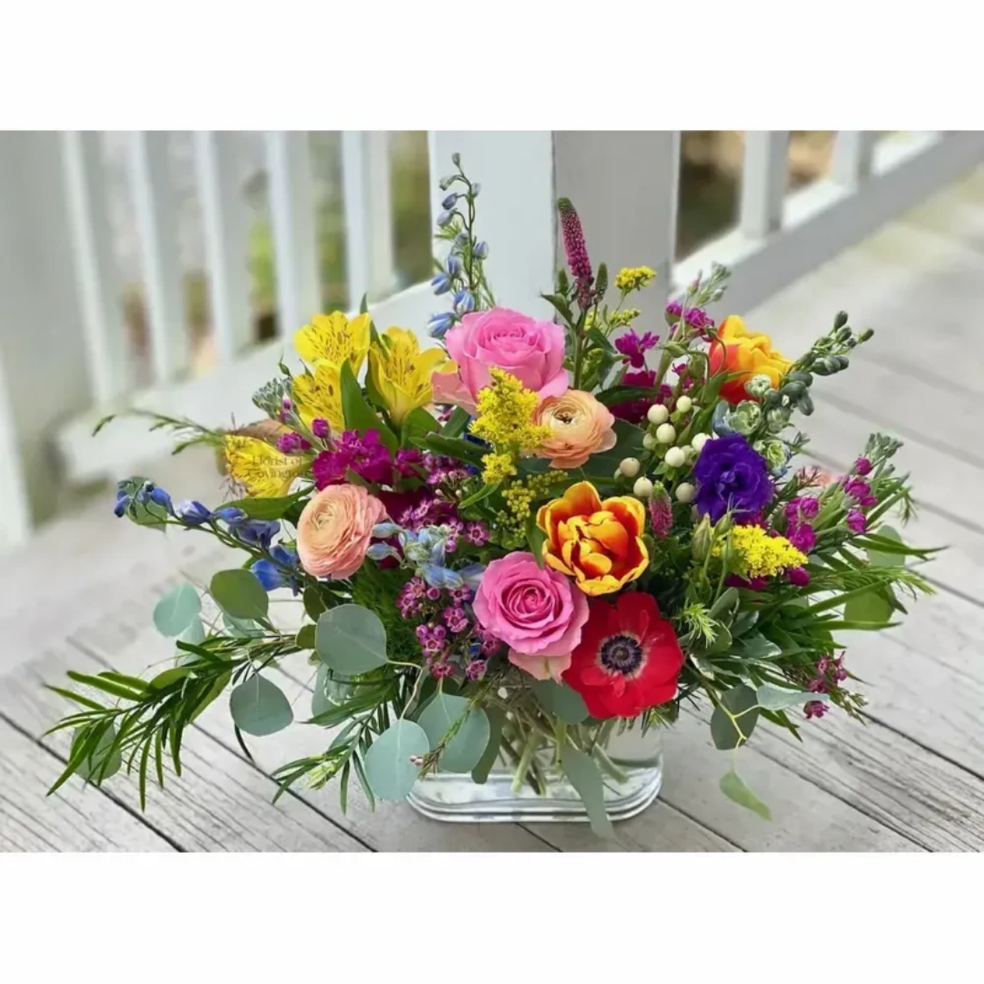 Mixed bouquet of colorful flowers in a clear glass vase