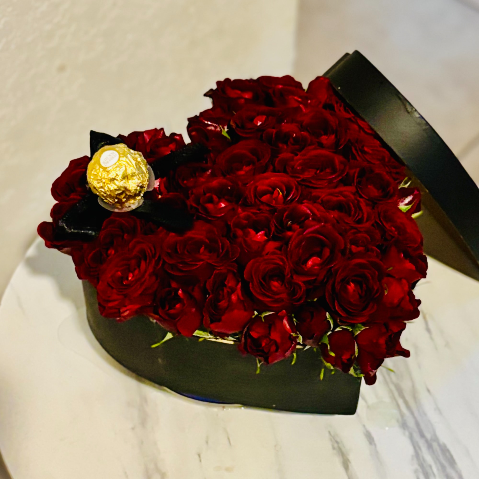 Bouquet of red roses with a Ferrero Rocher chocolate on top