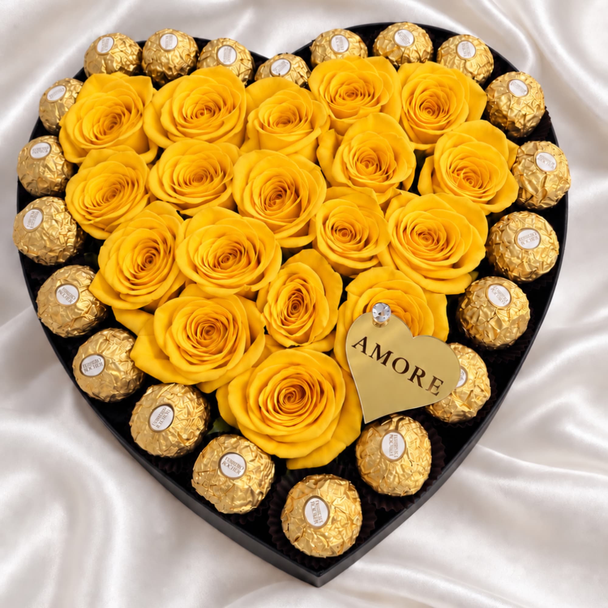 Heart-shaped box with yellow roses and gold-wrapped chocolates