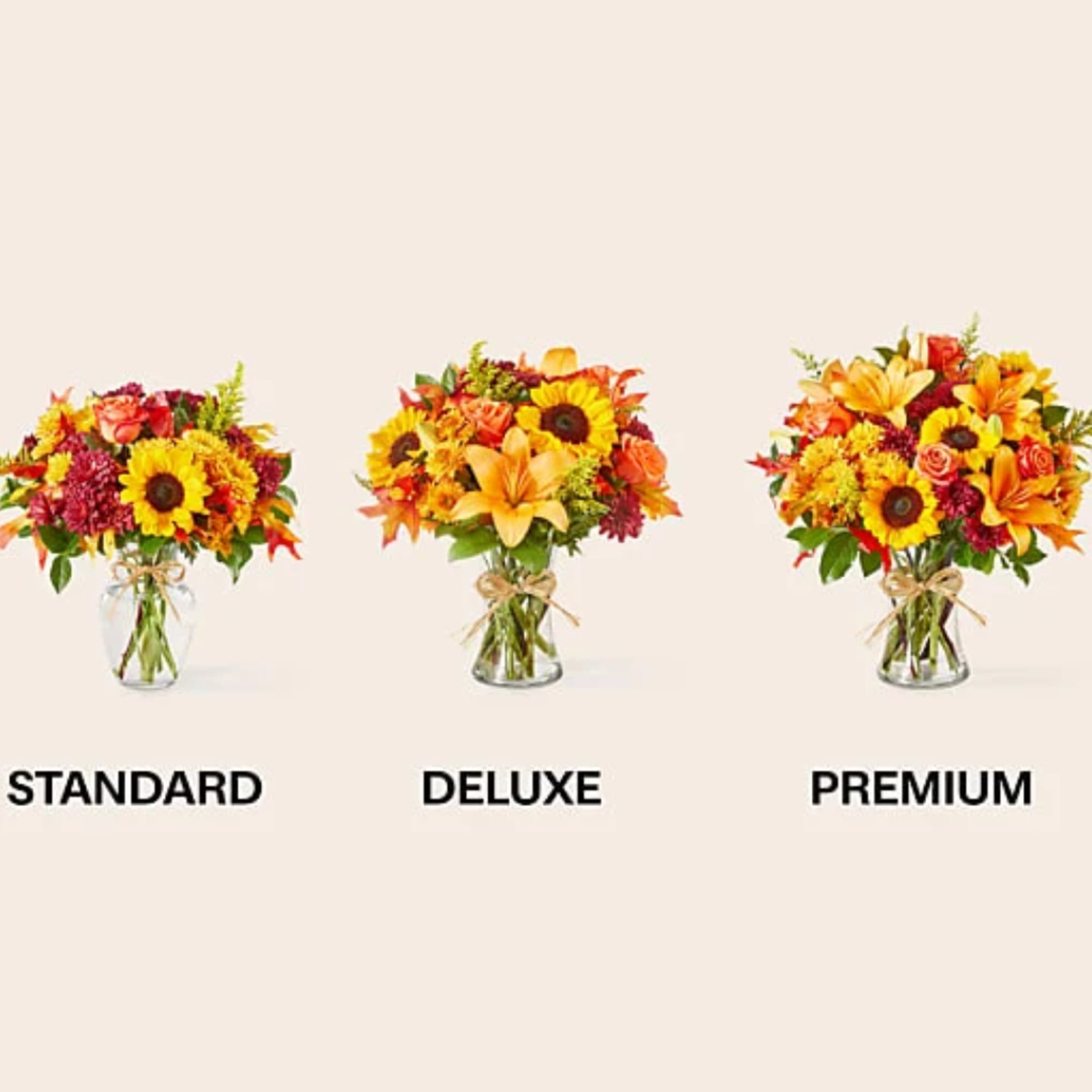 Three autumn flower arrangements in glass vases labeled standard, deluxe, and premium.
