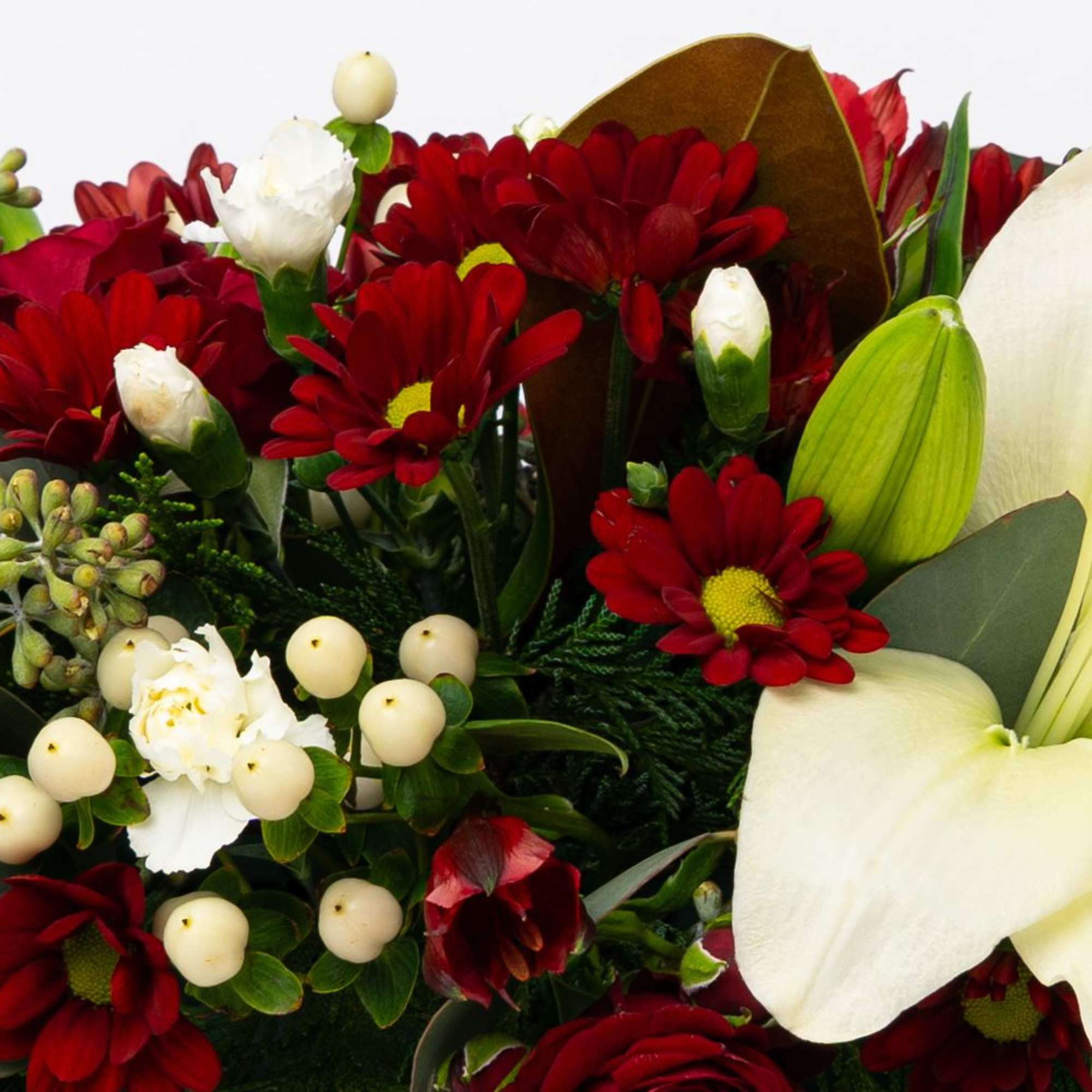 Bouquet of red daisies and white lilies with berries