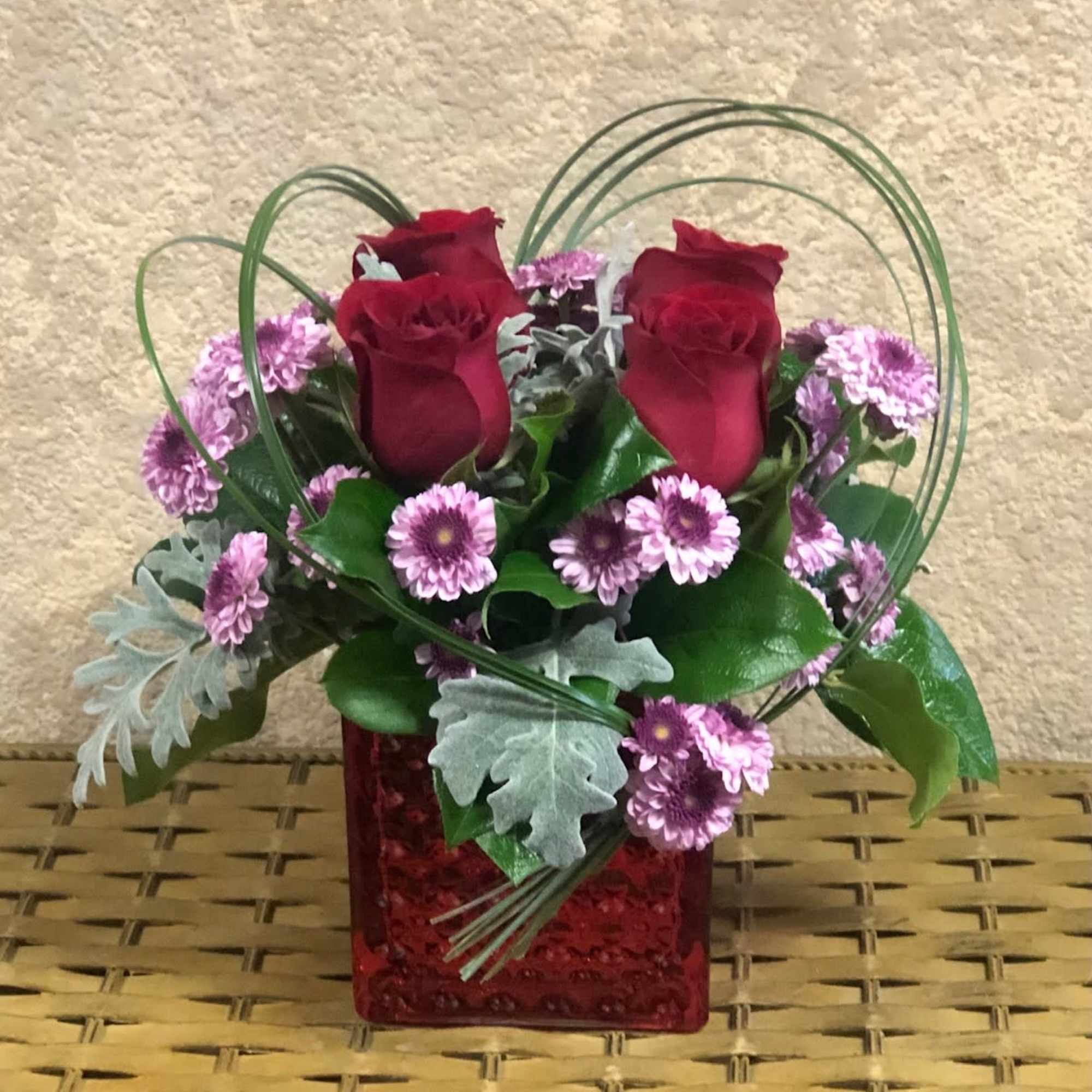 Recipe: Red Roses, Purple Chrysanthemums, and greens in a short, red vase.
Availability:, photo 2 of 2