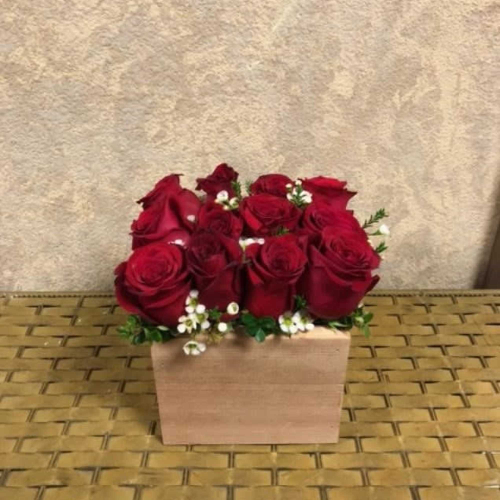 Type of Flowers: Red Roses and filler in a handmade, reusable, wooden