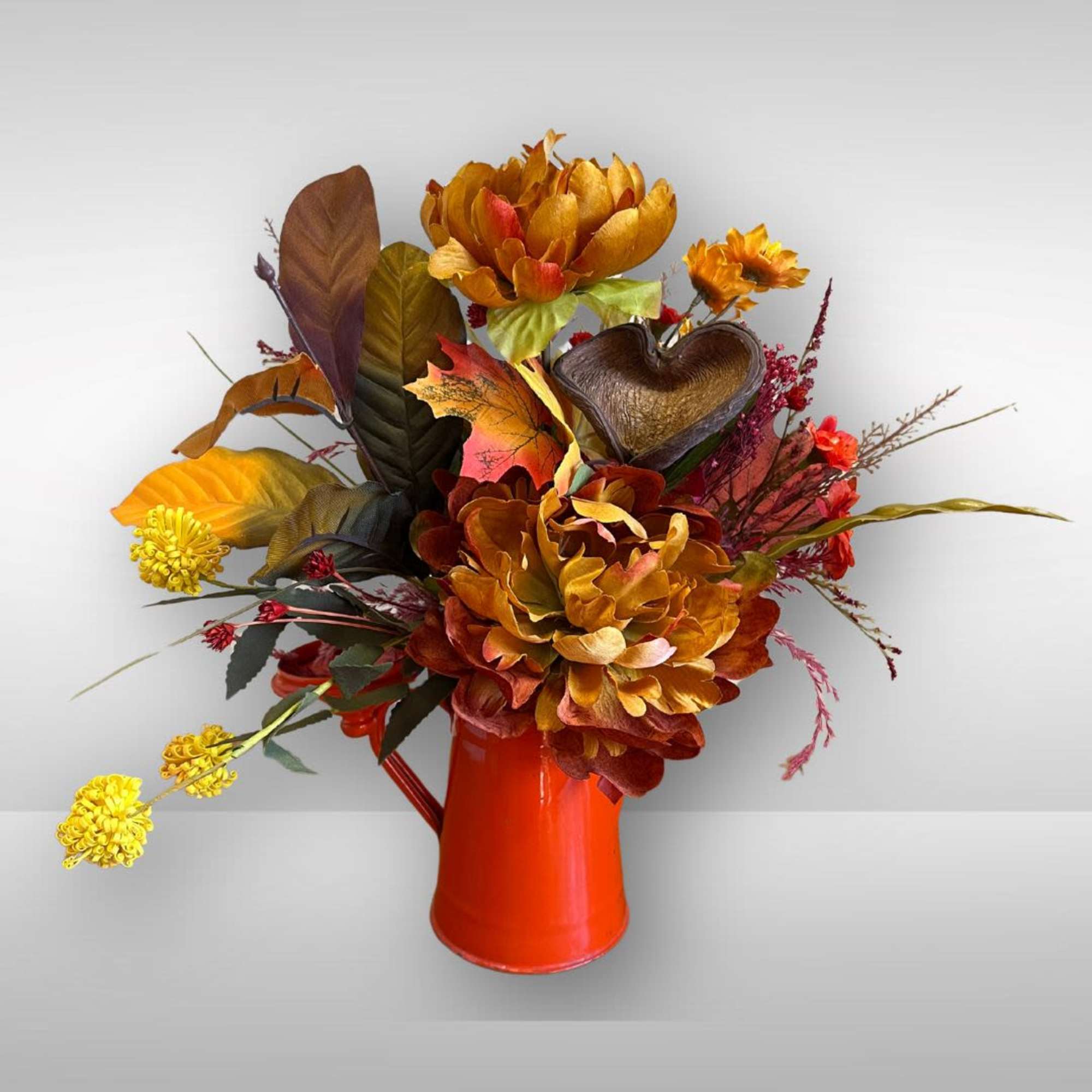 Silk arrangement in a orange vintage coffee pot with a scarecrow., photo 2 of 2