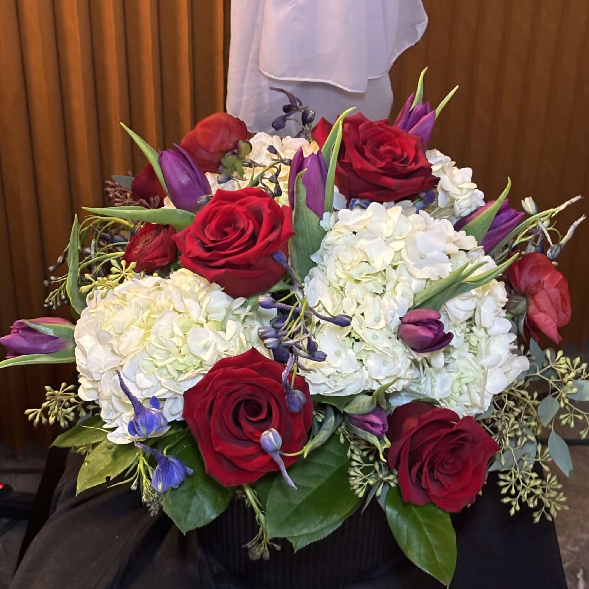 Bouquet of red roses, white hydrangeas, and purple tulips