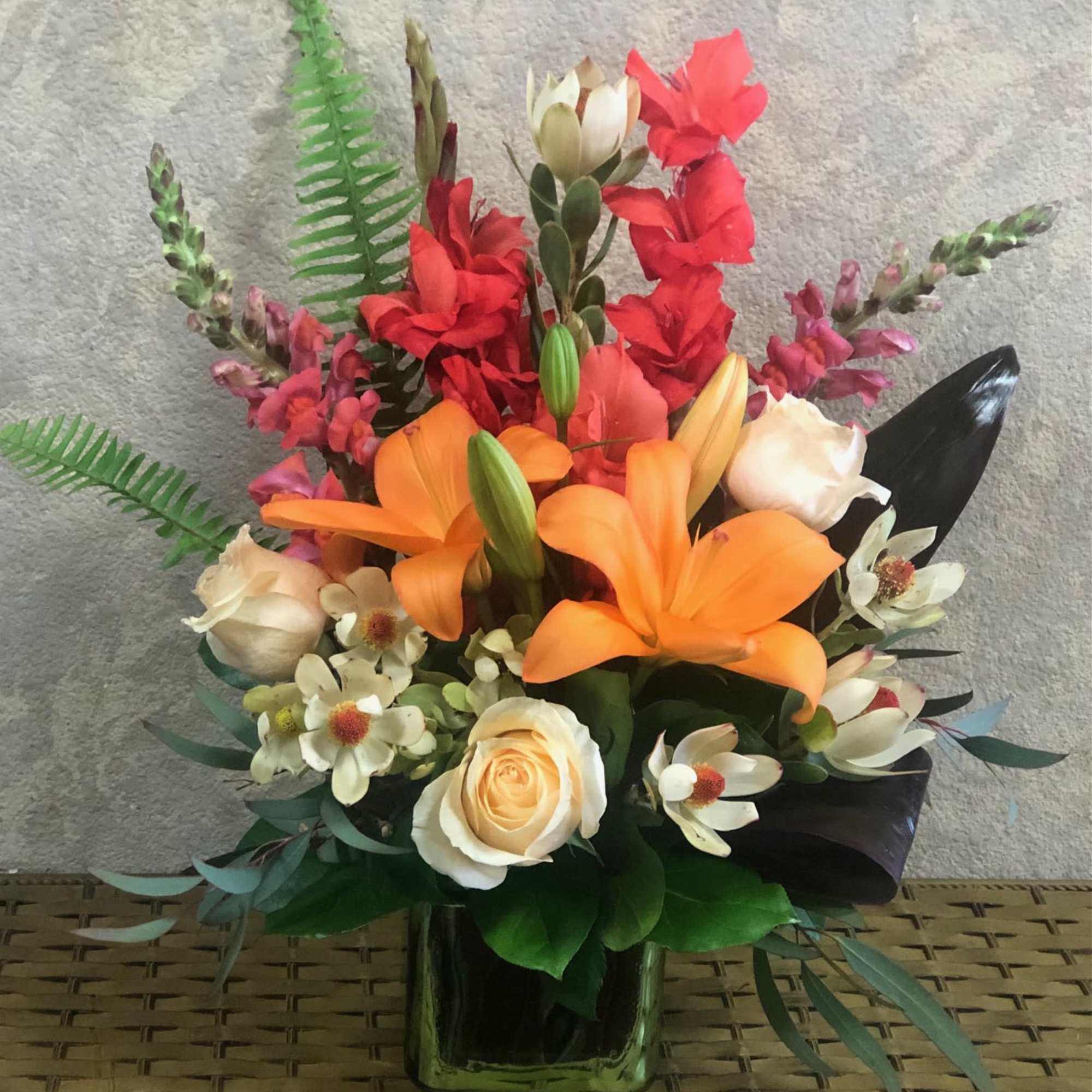 A beautiful safarian sunset with Orange Lilies, Cream Roses, Snapdragons, Gladiolas, and